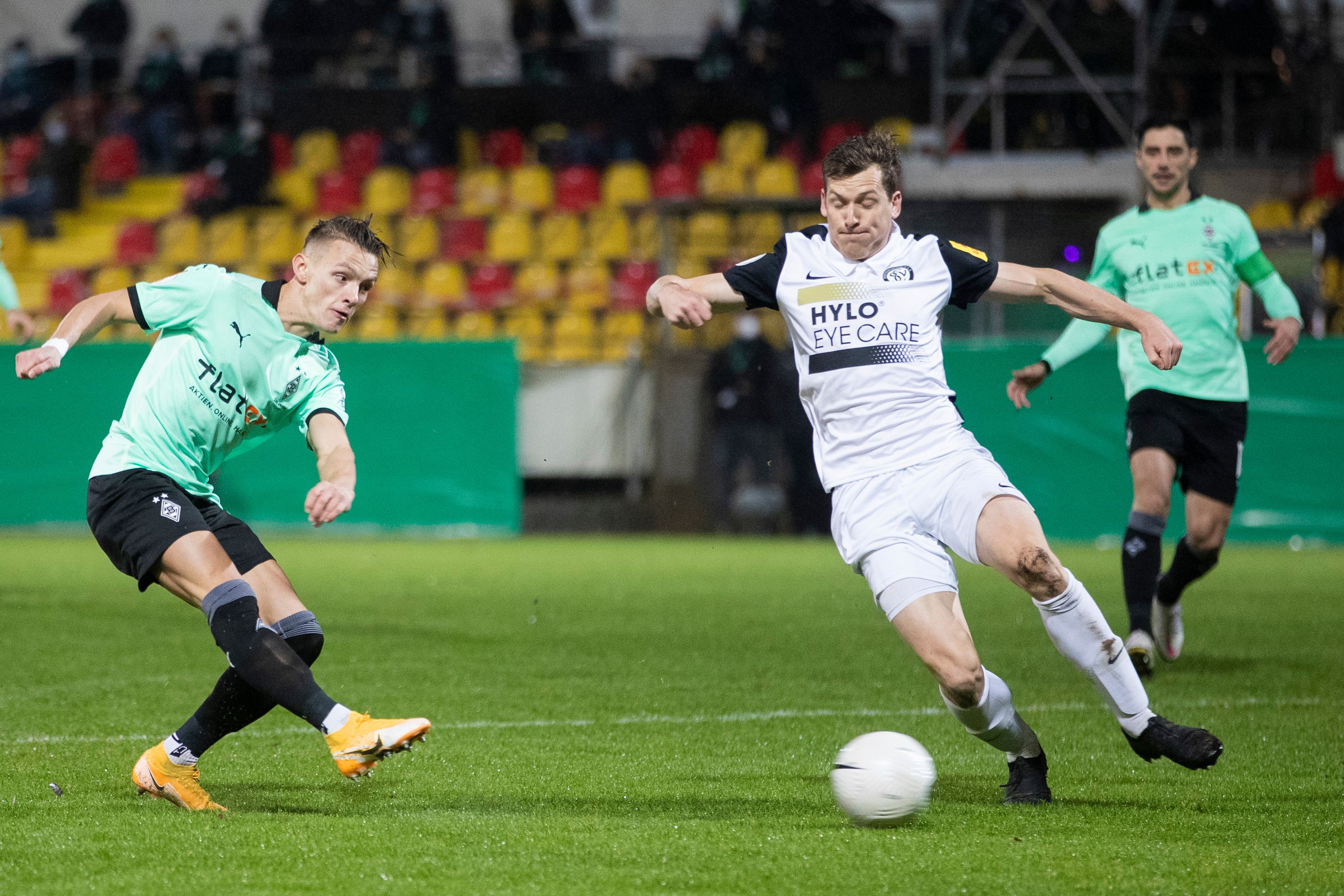 Gladbachs Hannes Wolf (l) macht das Tor zum 0:1 gegen Elversbergs Lukas Kohler (M).