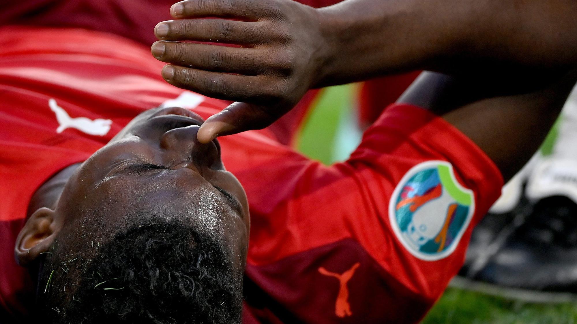 Gladbachs Breel Embolo zog sich im EM-Viertelfinale der Schweiz gegen Spanien am 2. Juli 2021 in St. Petersburg eine Oberschenkelverletzung zu und fällt nun bis auf Weiteres aus. Das Foto zeigt den Schweizer mit Schmerz verzerrtem Gesicht leidend auf dem Boden liegend.