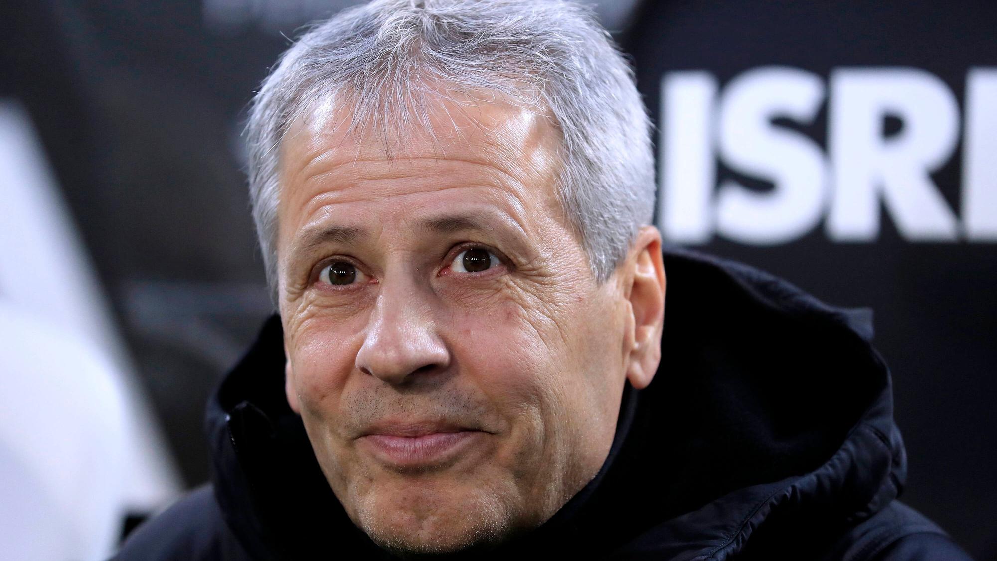 Lucien Favre in der Nahaufnahme: Er trägt eine schwarze Winterjacke und schmunzelt.