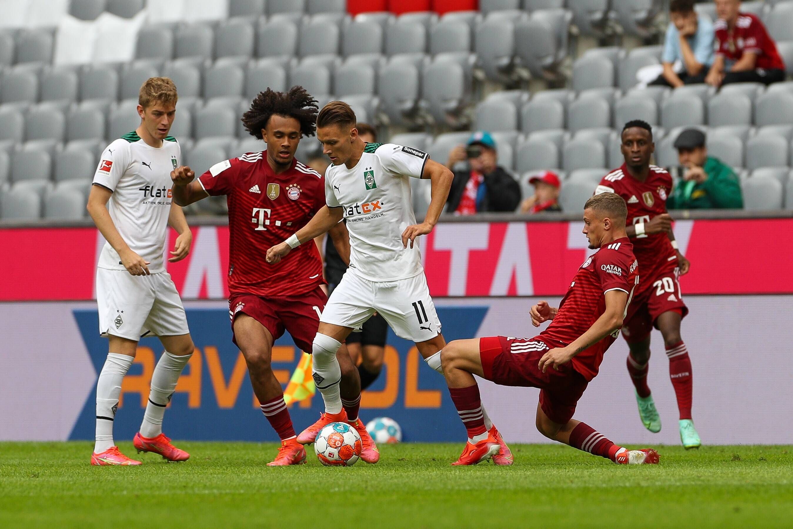 Bayerns Joshua Zirkzee Im Zweikampf mit den Gladbachern Andreas Poulsen (l) und Hannes Wolf (r.) während des Testspiels am 28. Juli 2021.