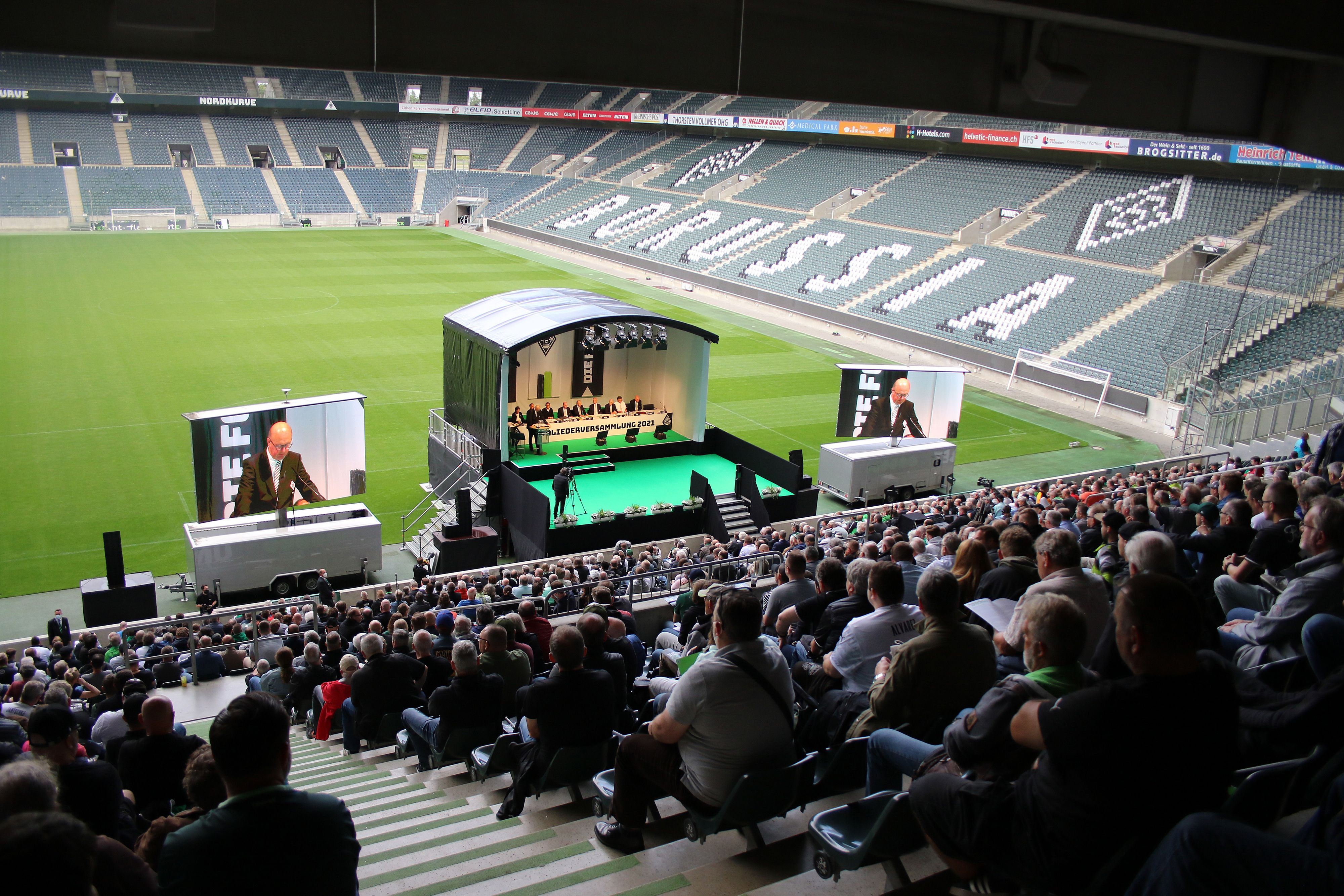 Mitglieder von Borussia Mönchengladbach sitzen auf der Südtribüne des Borussia-Parks und hören zu, was das Präsidium des VfL zu berichten hat.