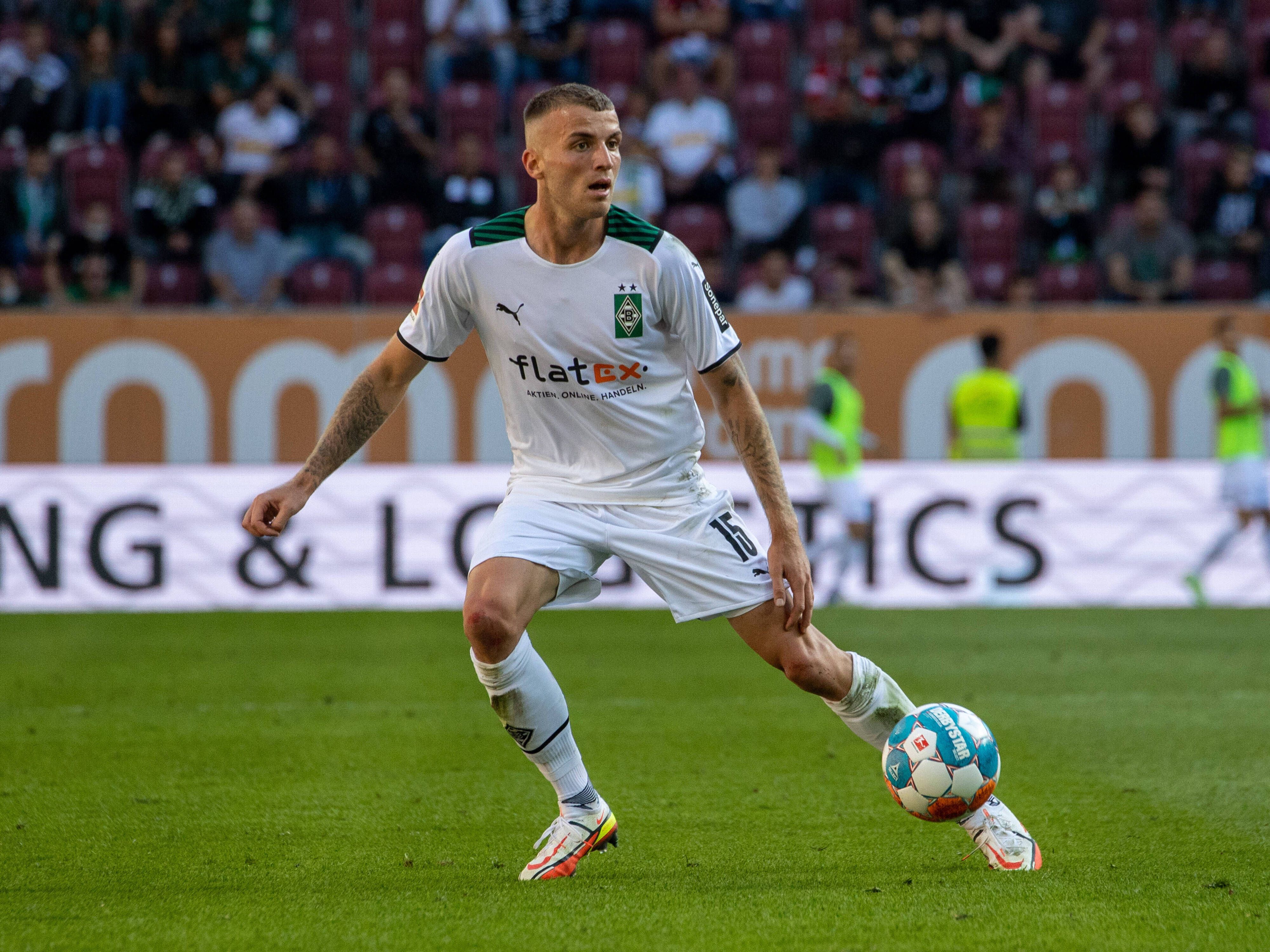 Louis Jordan Beyer von Borussia Mönchengladbach, hier zu sehen am 18. September 2021 in Augsburg, ist für die U21-Nationalelf des DFB nominiert worden. Beyer blickt auf das Spielfeld, während der Ball vor ihm ist.