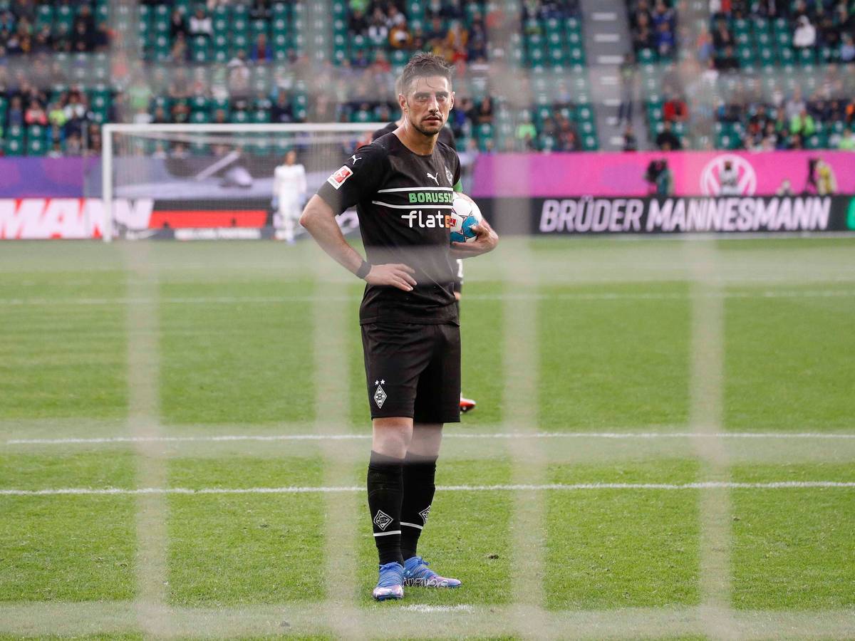Gladbach-Kapitän Lars Stindl vor seinem Strafstoß im Bundesliga-Duell beim VfL Wolfsburg am 2. Oktober 2021 in der VW-Arena. Stindl hat den Ball unter den Arm geklemmt.