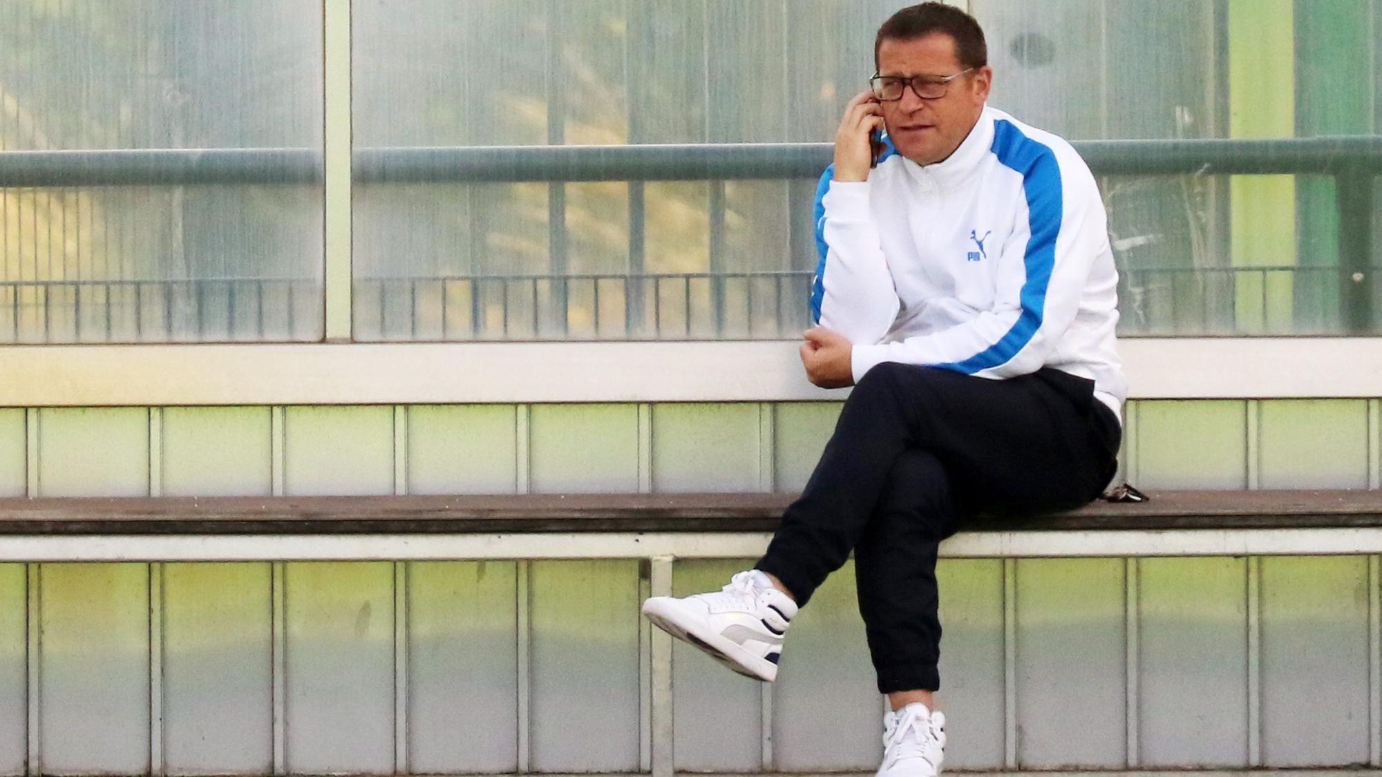 Max Eberl, Manager von Fußball-Bundesligist Borussia Mönchengladbach. Auf diesem Foto ist der 48-Jährige am 6. Juli 2021 zu sehen. Eberl sitzt auf einer Auswechselbank und telefoniert.