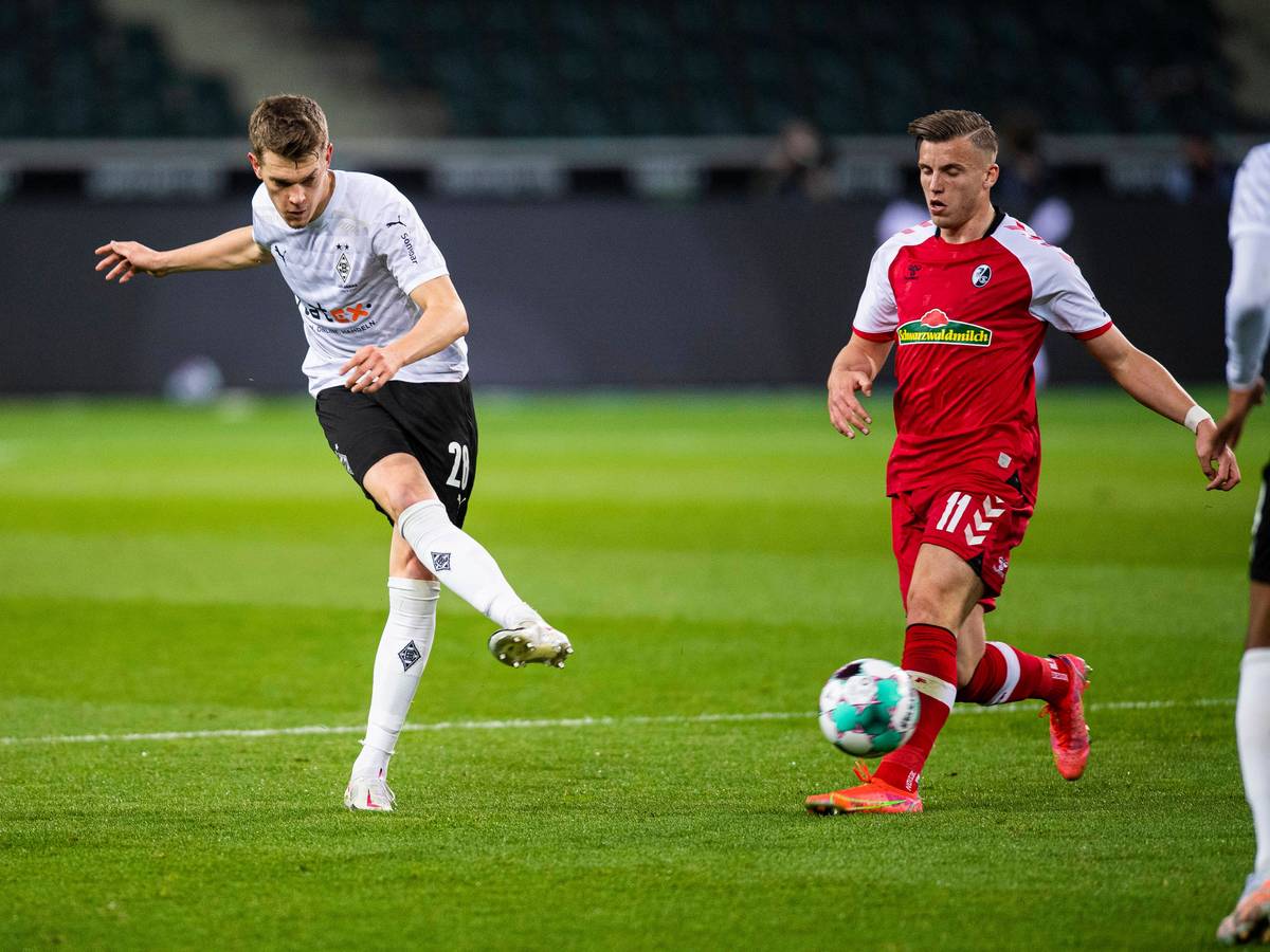 Matthias Ginter (l.), Verteidiger von Borussia Mönchengladbach. Auf diesem Foto ist der DFB-Nationalspieler im Bundesliga-Spiel gegen den SC Freiburg am 3. April 2021 zu sehen. Ginter spielt einen Pass.