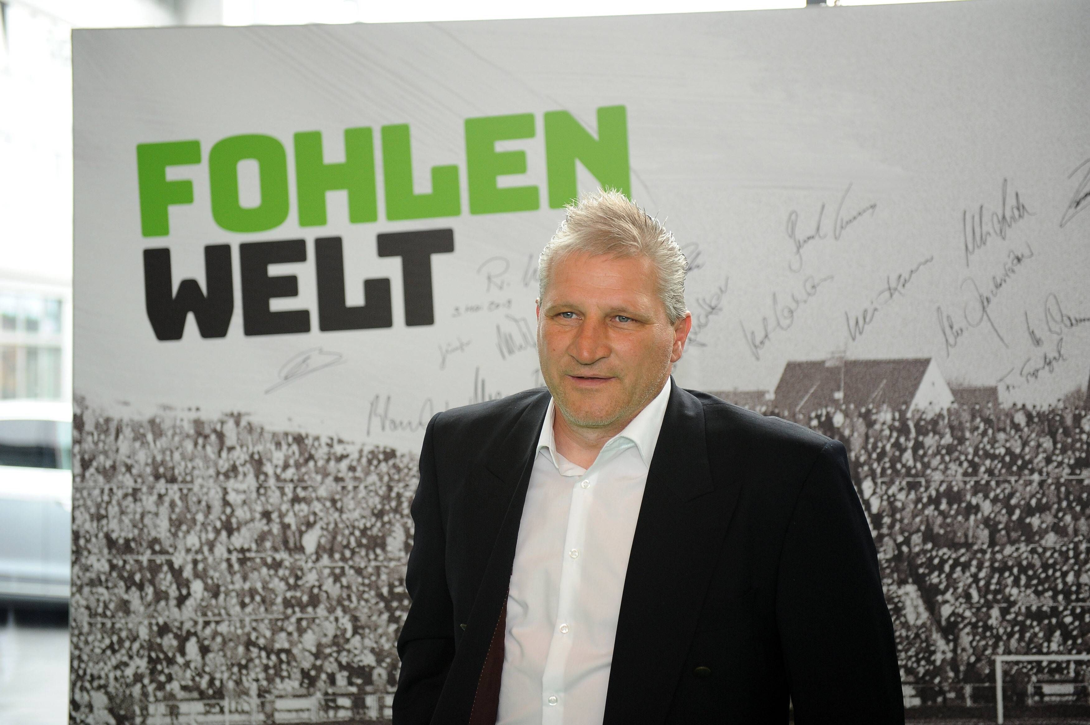 Thomas Kastenmaier im Borussia-Park. Auf diesem Foto ist der ehemalige Profi von Borussia Mönchengladbach am 3. Mai 2019 zu sehen. Kastenmaier steht vor einer Pappwand, auf der zahlreiche Ex-Profis der Borussia unterschrieben haben.