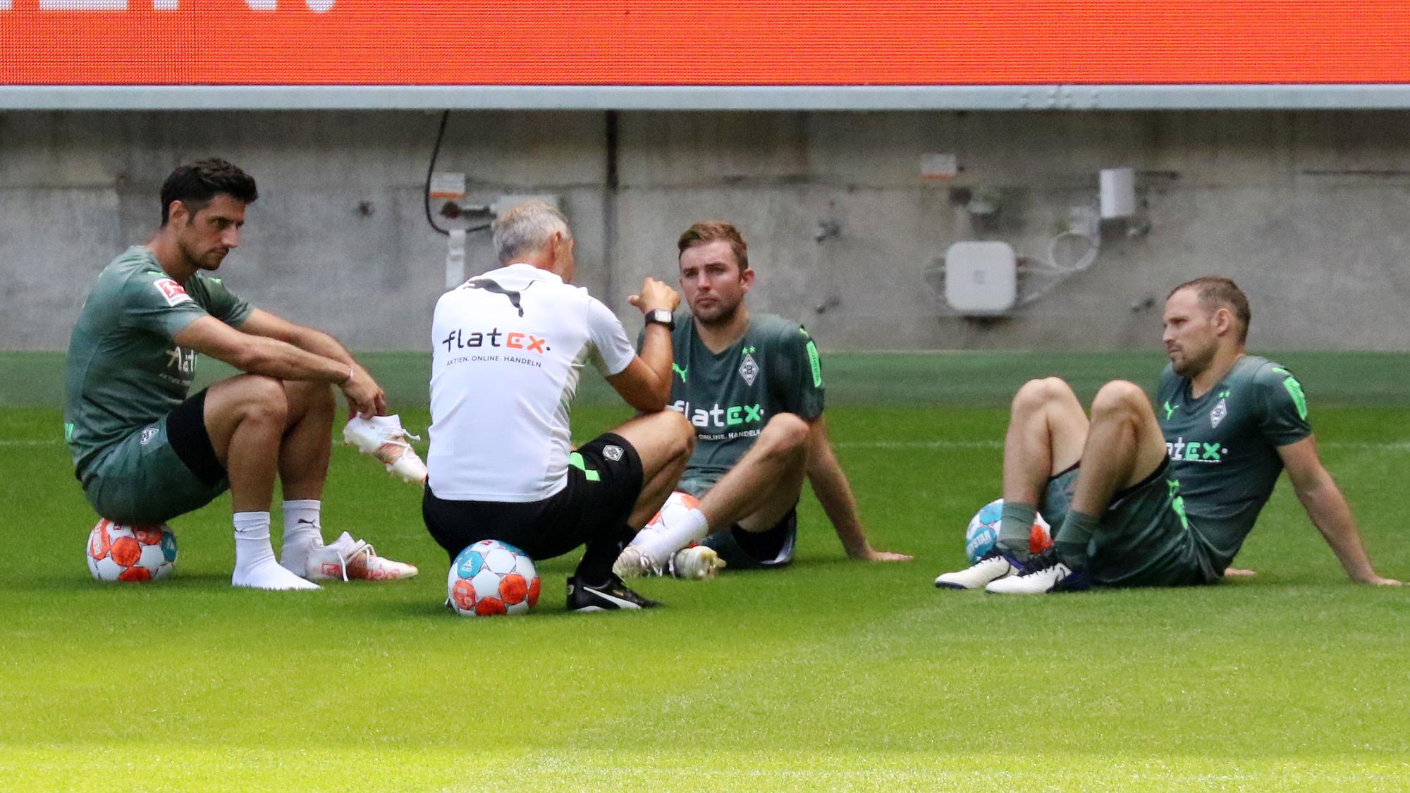 Gladbachs Christoph Kramer (Mitte) nach der Trainingseinheit am 4. Juli 2021 im Gespräch mit seinen Teamkollegen Lars Stindl (links) und Tony Jantschke (rechts) sowie Trainer Adi Hütter (vorne) im Borussia-Park.