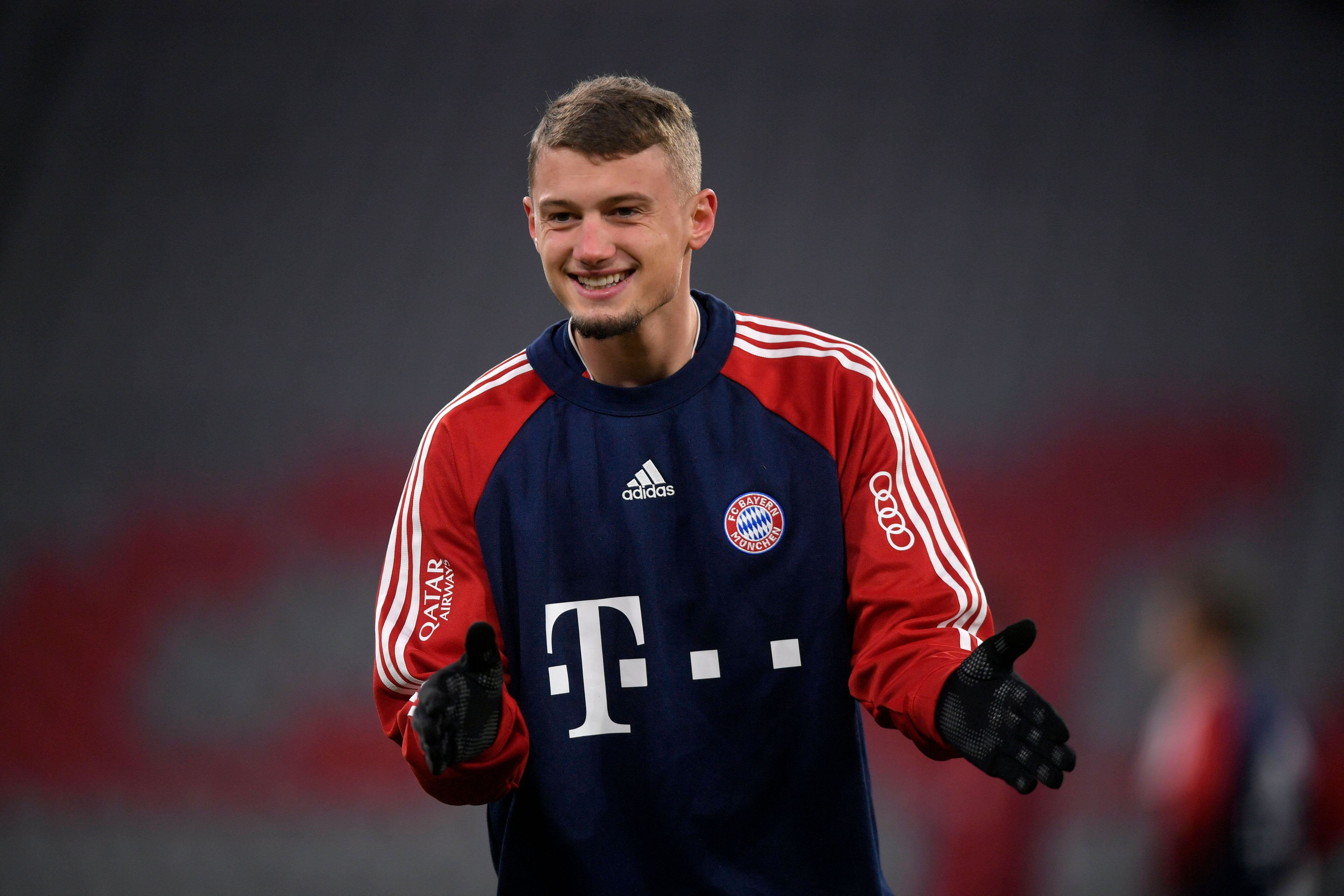 Michael Cuisance lächelt am 17. Dezember 2021 beim Spiel des FC Bayern gegen den VfL Wolfsburg.