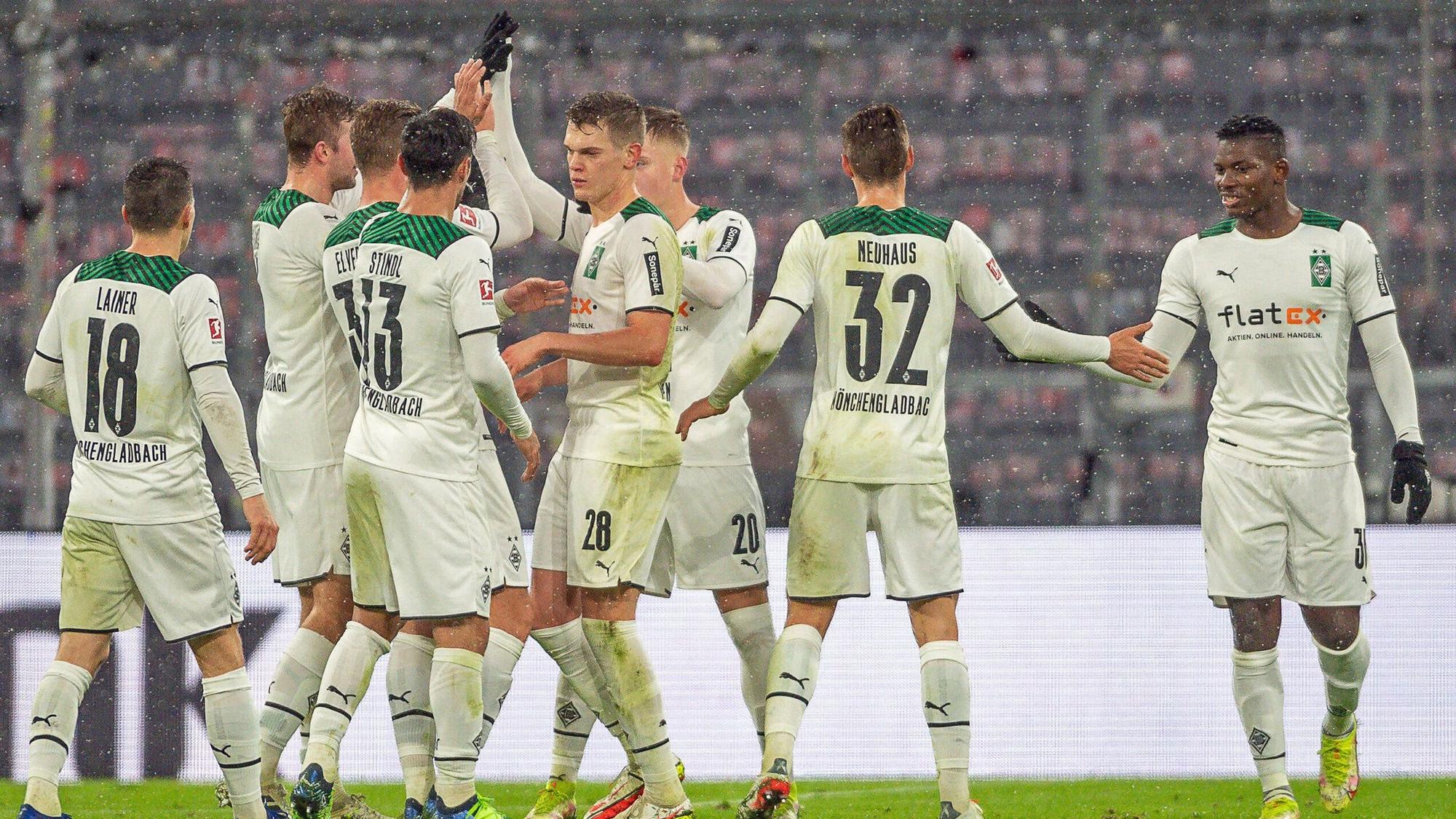 Spieler von Borussia Mönchengladbach klatschen sich beim Rückrunden-Auftaktsieg bei Bayern München (7. Januar 2022) in der Allianz-Arena ab. Zu sehen sind Profis wie Matthias Ginter, Florian Neuhaus oder Stefan Lainer.