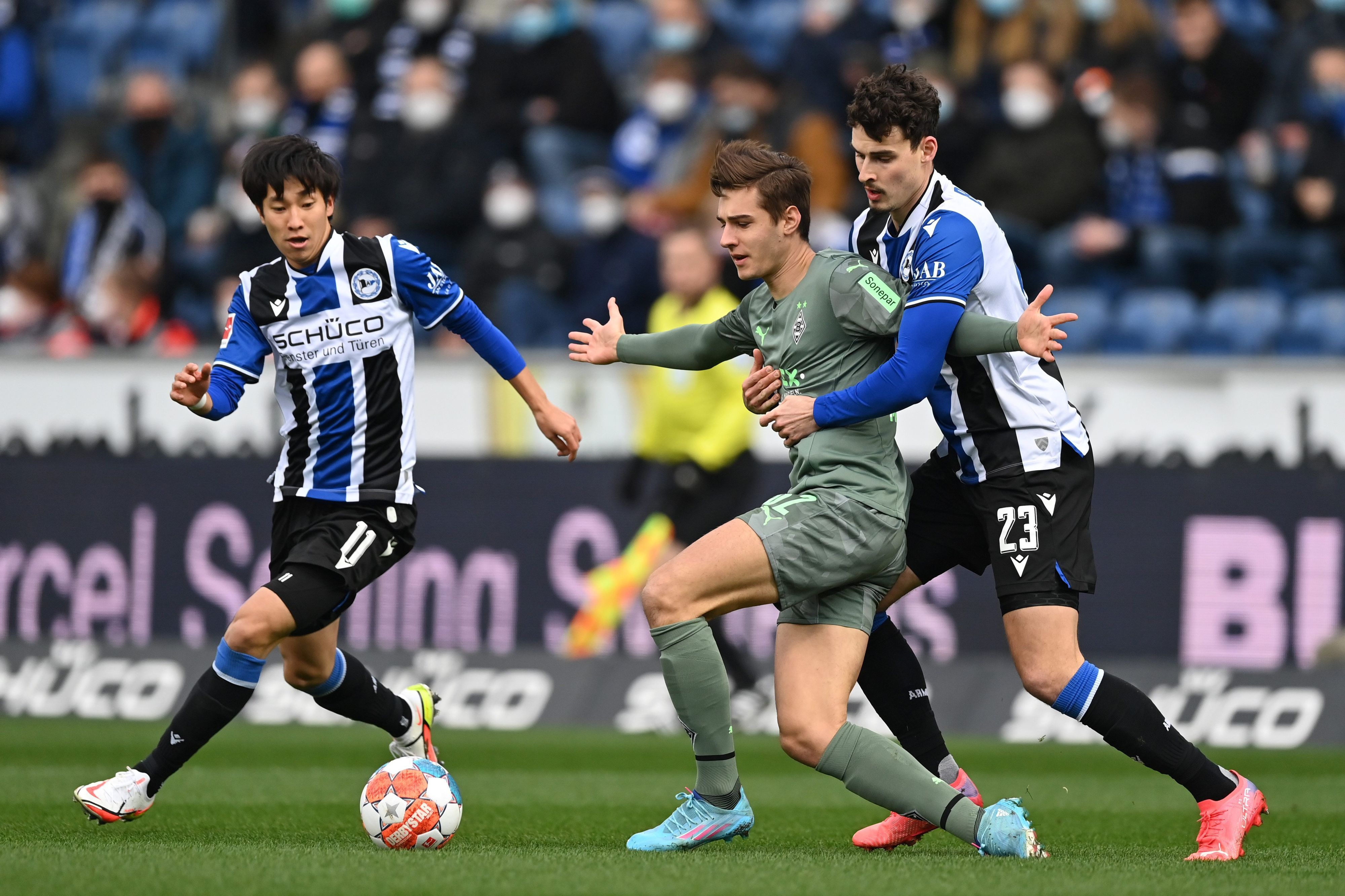 Bielefeld gegen Gladbach: Janni Serra (r.) und Florian Neuhaus (Mitte) beim Zweikampf.