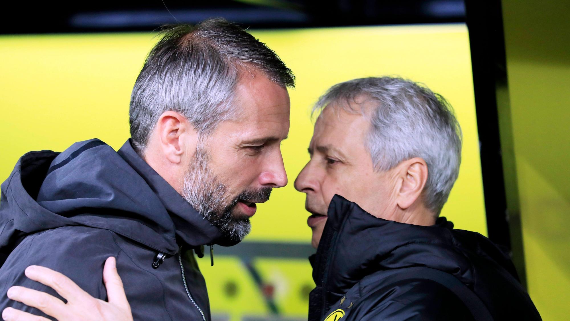 Das Fanprojekt von Borussia Mönchengladbach hat noch einmal mit Ex-Trainer Marco Rose (l.) abgerechnet und segnet die nahende Entscheidung, dass Lucien Favre (r.) neuer Fohlen-Coach werden soll, ab. Auf diesem Foto sind Favre und Rose am 19. Oktober 2019 in Dortmund zu sehen. Favre und Rose umarmen sich.