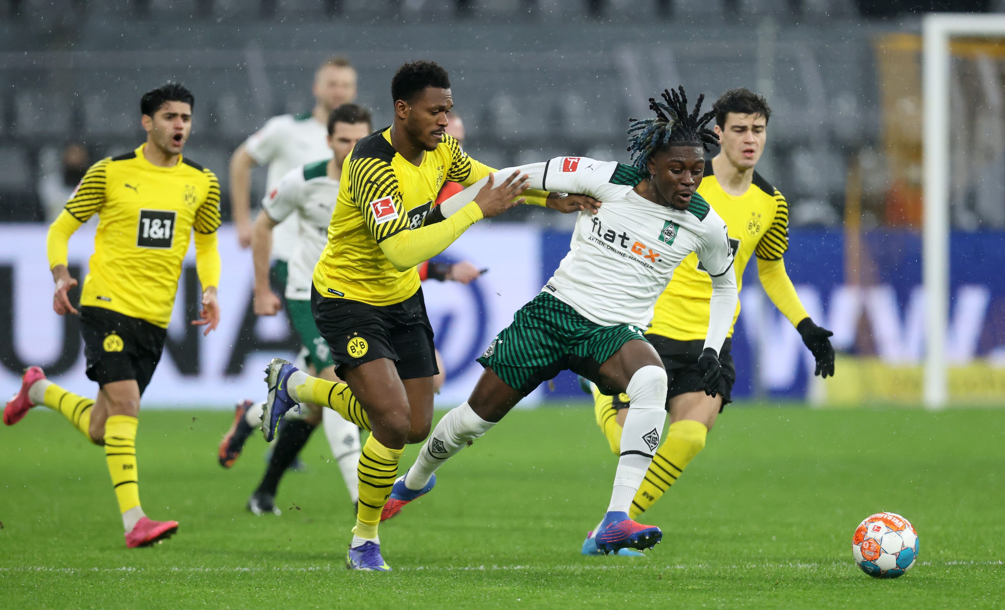 DORTMUND, GERMANY - FEBRUARY 20: Dan-Axel Zagadou of Borussia Dortmund battles for possession with Kouadio Kone of Borussia Monchengladbach during the Bundesliga match between Borussia Dortmund and Borussia Mönchengladbach at Signal Iduna Park on February 20, 2022 in Dortmund, Germany. (Photo by Alex Grimm/Getty Images)