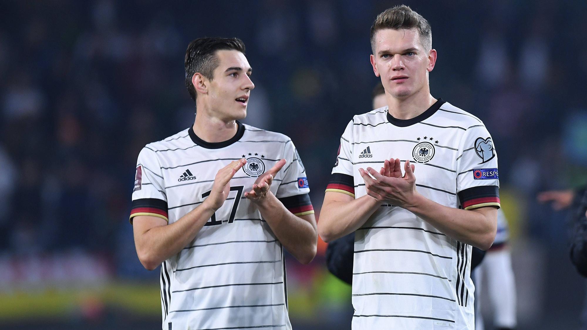 Florian Neuhaus (l.) und Matthias Ginter (r.) im Trikot der deutschen Fußball-Nationalmannschaft. Auf diesem Bild sind die beiden Profis von Borussia Mönchengladbach am 11. November 2021 in Wolfsburg zu sehen. Neuhaus und Ginter klatschen in die Hände.