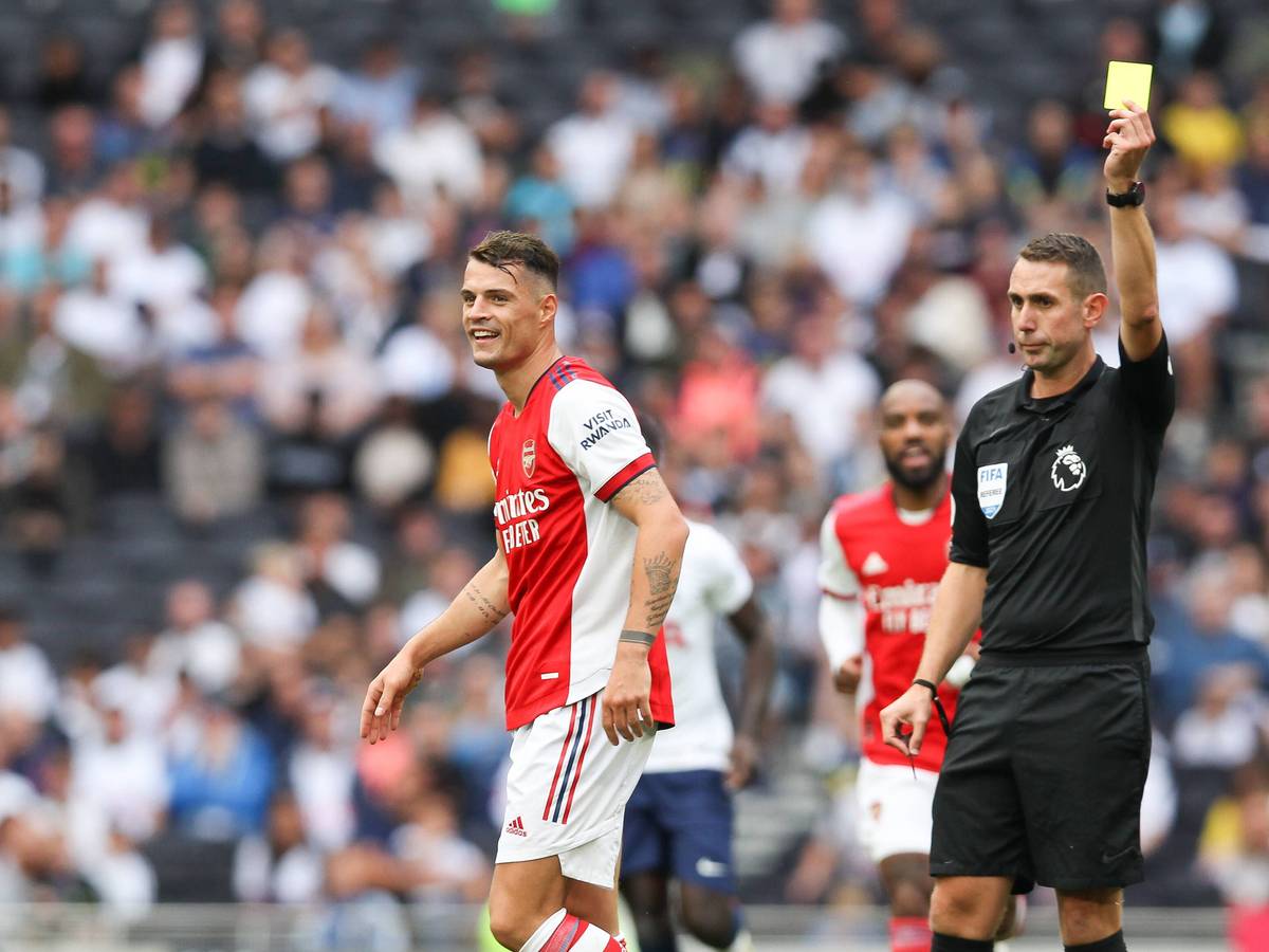 Granit Xhaka sieht eine Gelbe Karte, hier am 8. August 2021 bei einem Freundschaftsspiel von Arsenal gegen Tottenham. Xhaka wendet sich vom Schiedsrichter ab.