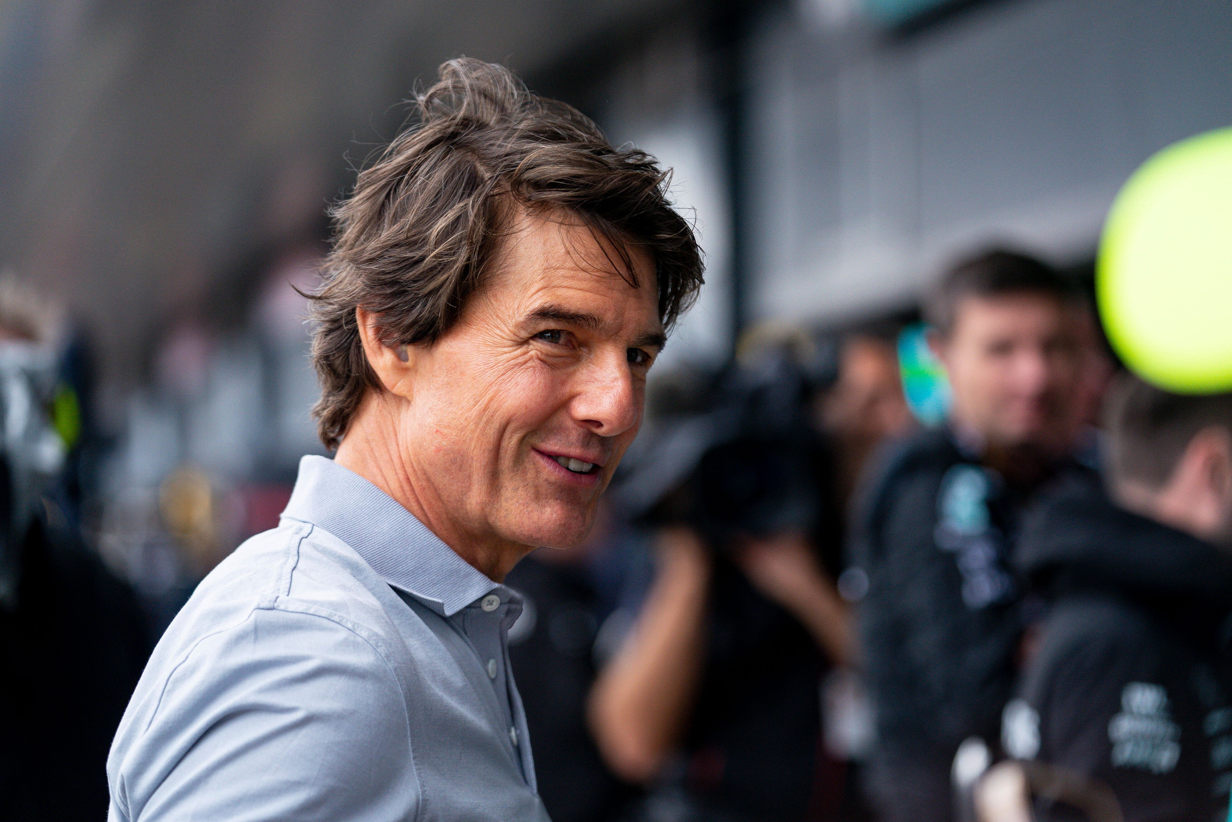 Hollywood-Star Tom Cruise hat beim Besuch des Formel-1-Rennens in Silverstone am Sonntag (3. Juli 2022) einen Profi von Borussia Mönchengladbach in der Boxengasse getroffen. Das Foto zeigt ihn Lächelnd.