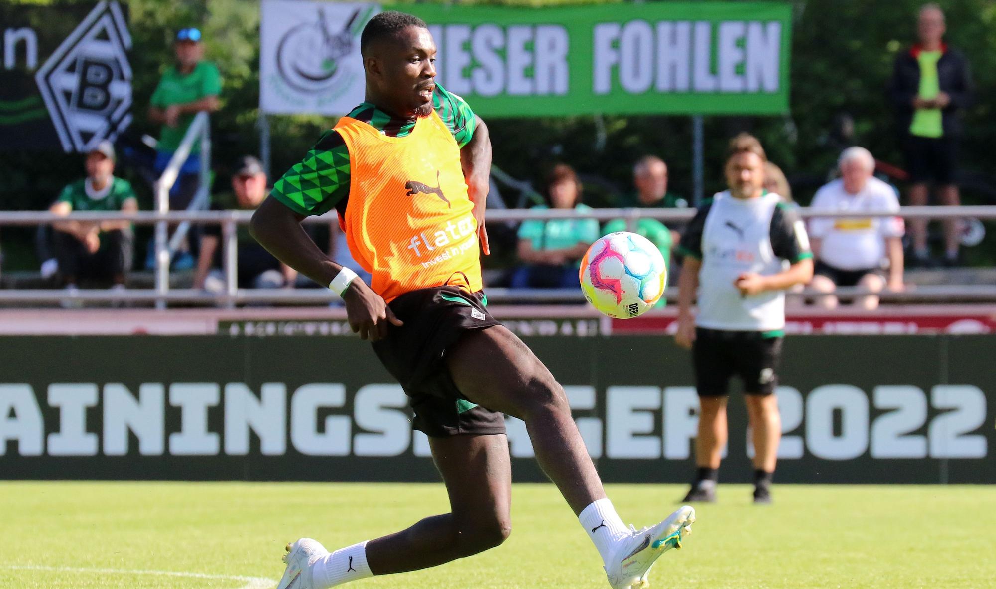 Marcus Thuram, hier am 5. Juli 2022 bei einer Einheit im Trainingslager, soll bei Borussia Mönchengladbach bleiben. Thuram nimmt den Ball mit dem rechten Fuß an, im Hintergrund wird er von Trainer Daniel Farke beobachtet.