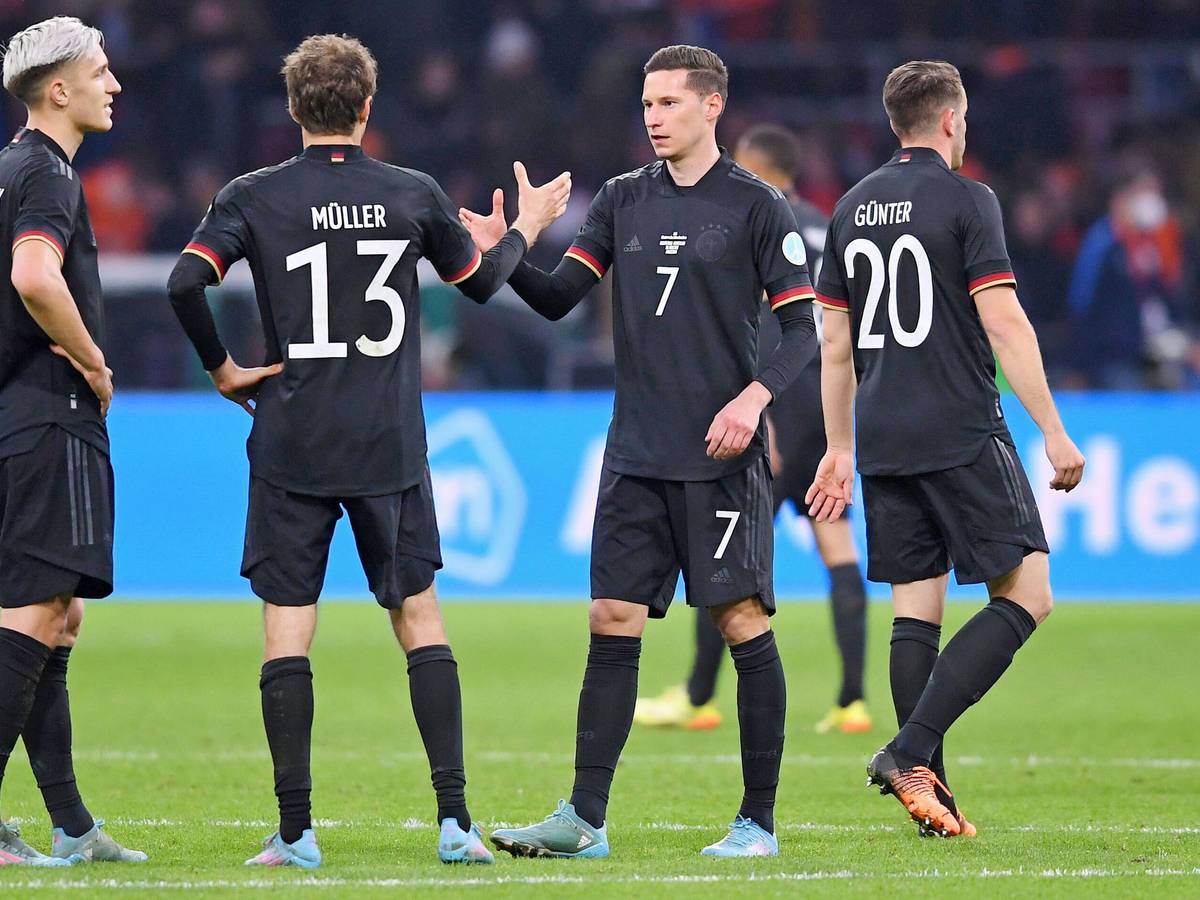 Er soll Thema in Gladbach sein: DFB-Nationalspieler Julian Draxler (2.v.r.) klatscht Thomas Müller (2.v.l.) beim Länderspiel gegen die Niederlande am 29. März 2022 in Amsterdam ab. Die deutschen Spieler tragen schwarze Trikots.
