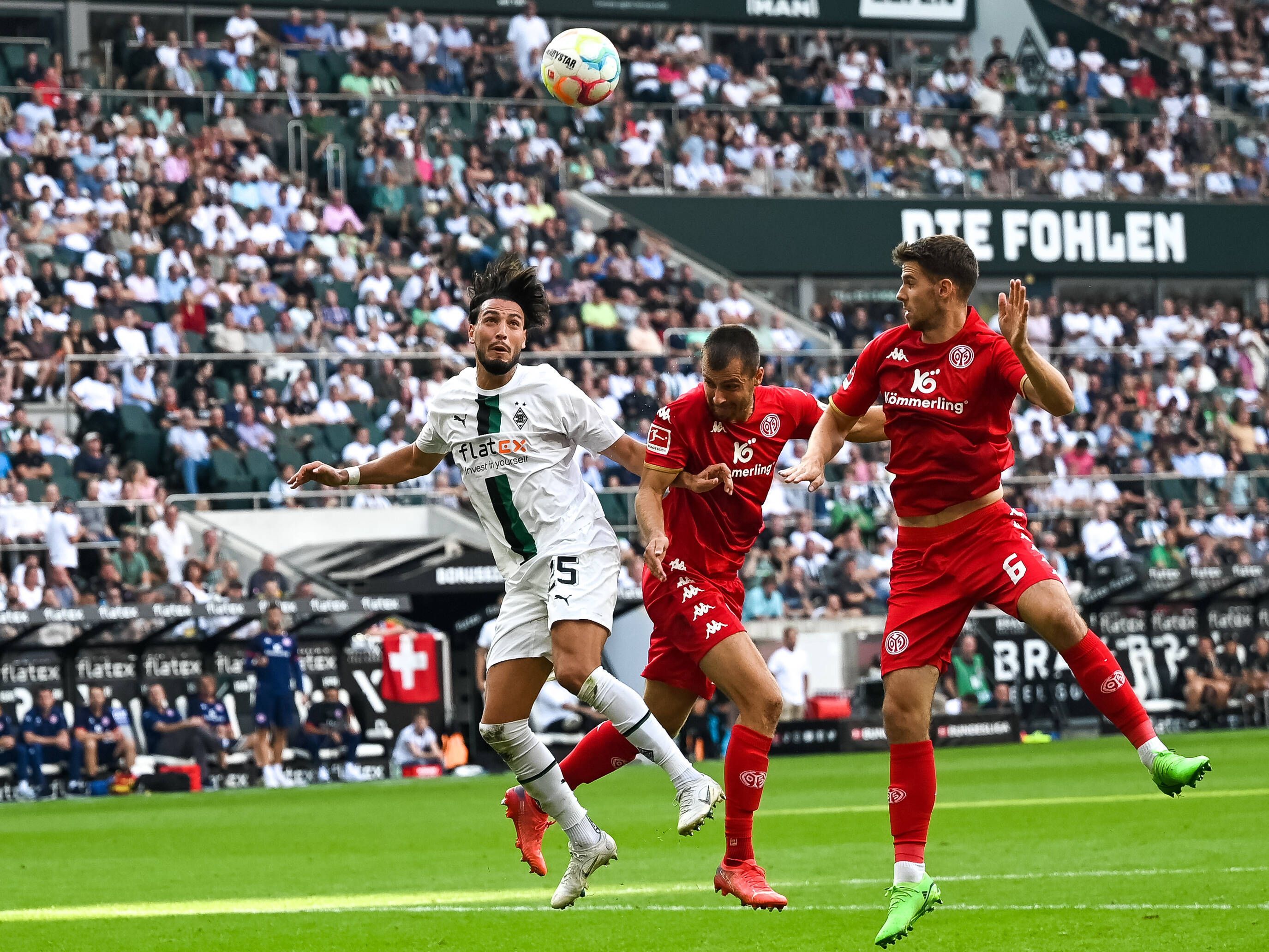 Ramy Bensebaini (l.) von Borussia Mönchengladbach, hier am 4. September 2022 im Kopfball-Duell mit zwei Mainzer-Spielern, wurde von den GladbachLIVE-Leserinnen und Lesern zum Spieler des Spiels gekürt.