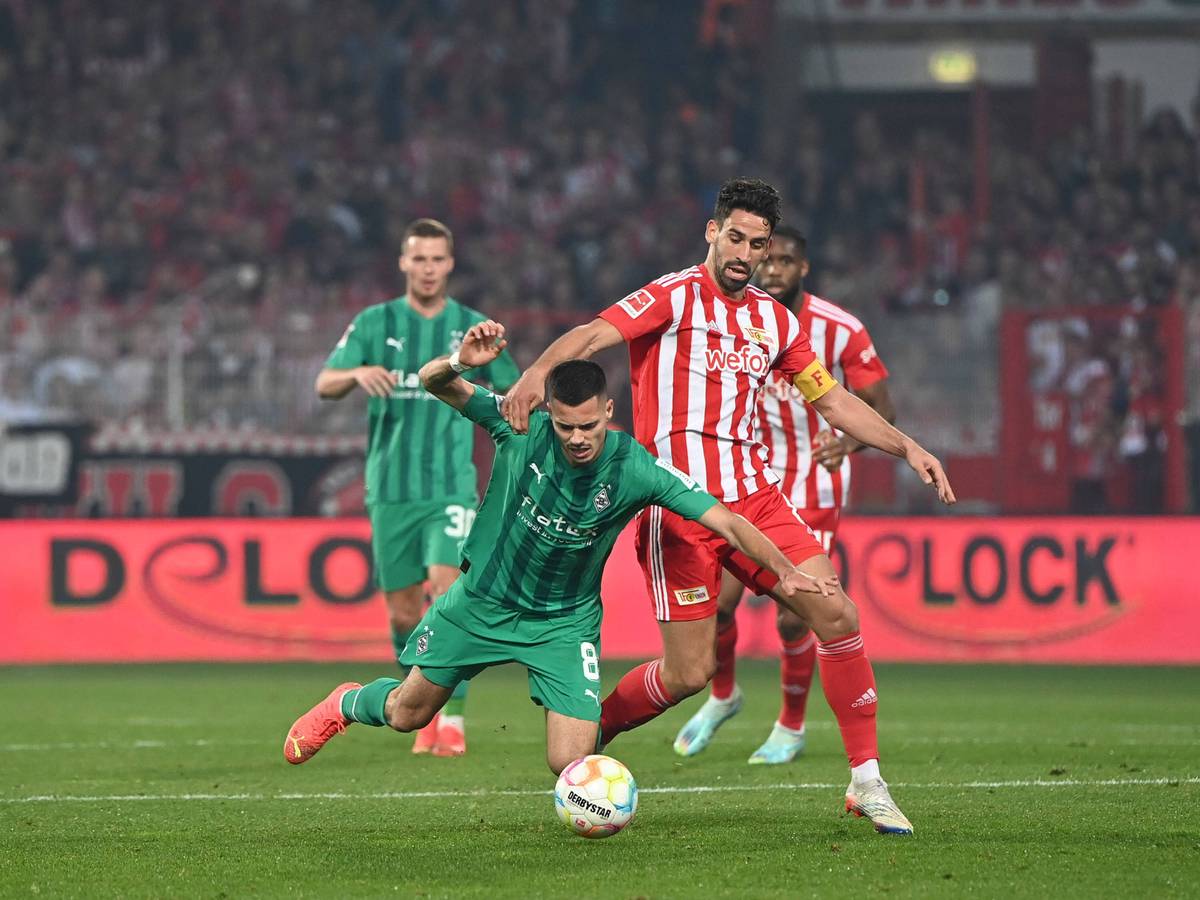 Julian Weigl von Borussia Mönchengladbach geht im Spiel bei Union Berlin am 30. Oktober 2022 zu Boden. Sein Gegenspieler ist Rani Khedira von Union Berlin.