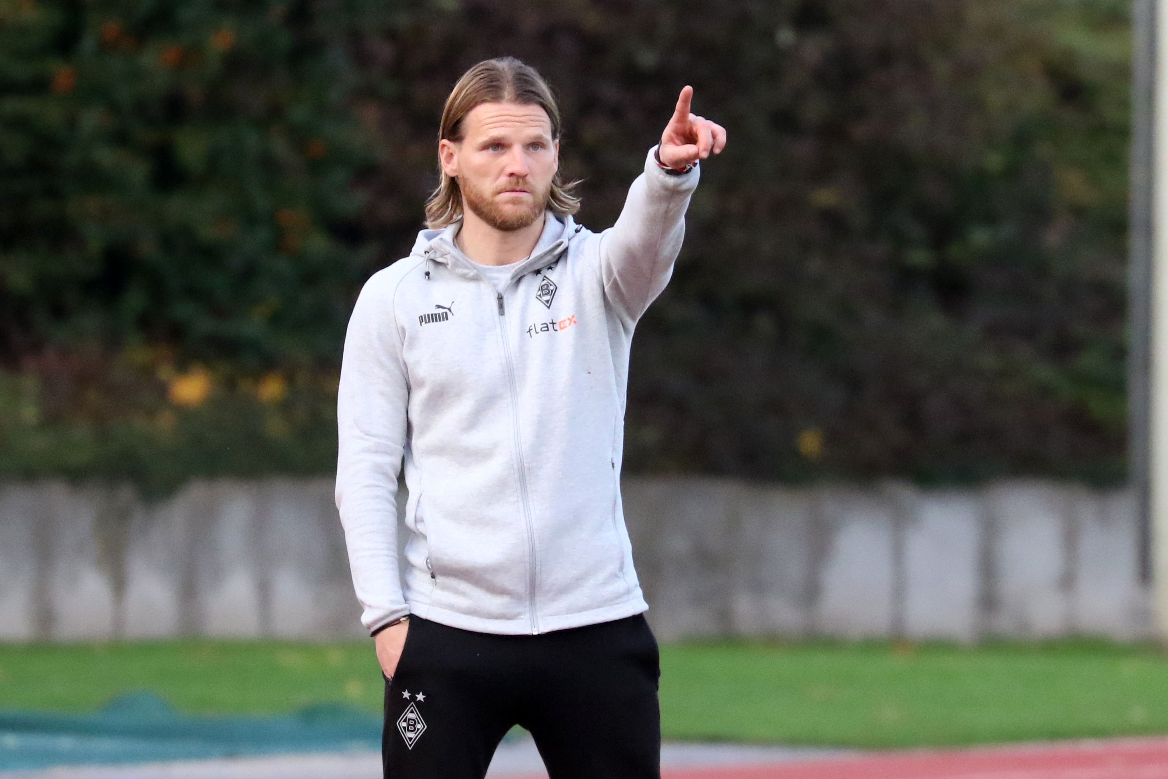 Eugen Polanski, Trainer der U23 von Borussia Mönchengladbach, zeigt mit dem linken Zeigefinger nach oben und gibt Anweisungen.