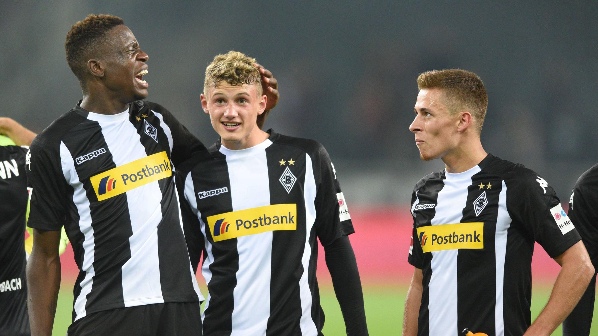 Denis Zakaria (l.), Michael Cuisance (M.) und Thorgan Hazard stehen nach dem Bundesliga-Spiel von Borussia Mönchengladbach gegen den VfB Stuttgart am 19. September 2017 in schwarz-weißen Gladbach-Trikots vor der Fankurve.