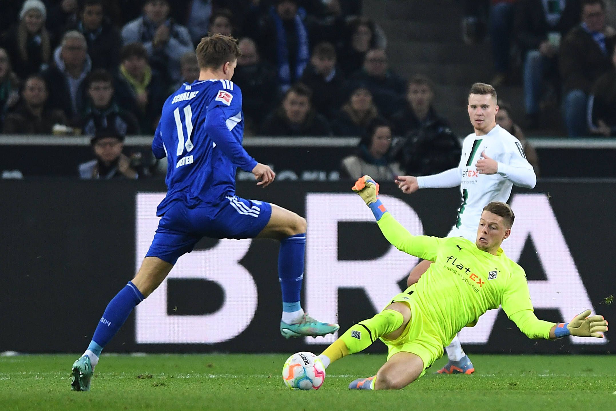 Voller Körpereinsatz. Gladbach-Torwart Jonas Omlin (r.) klärt am 4. Februar 2023 per Grätsche vor Schalke-Stürmer Marius Bülter. Im Hintergrund schaut Nico Elvedi zu.