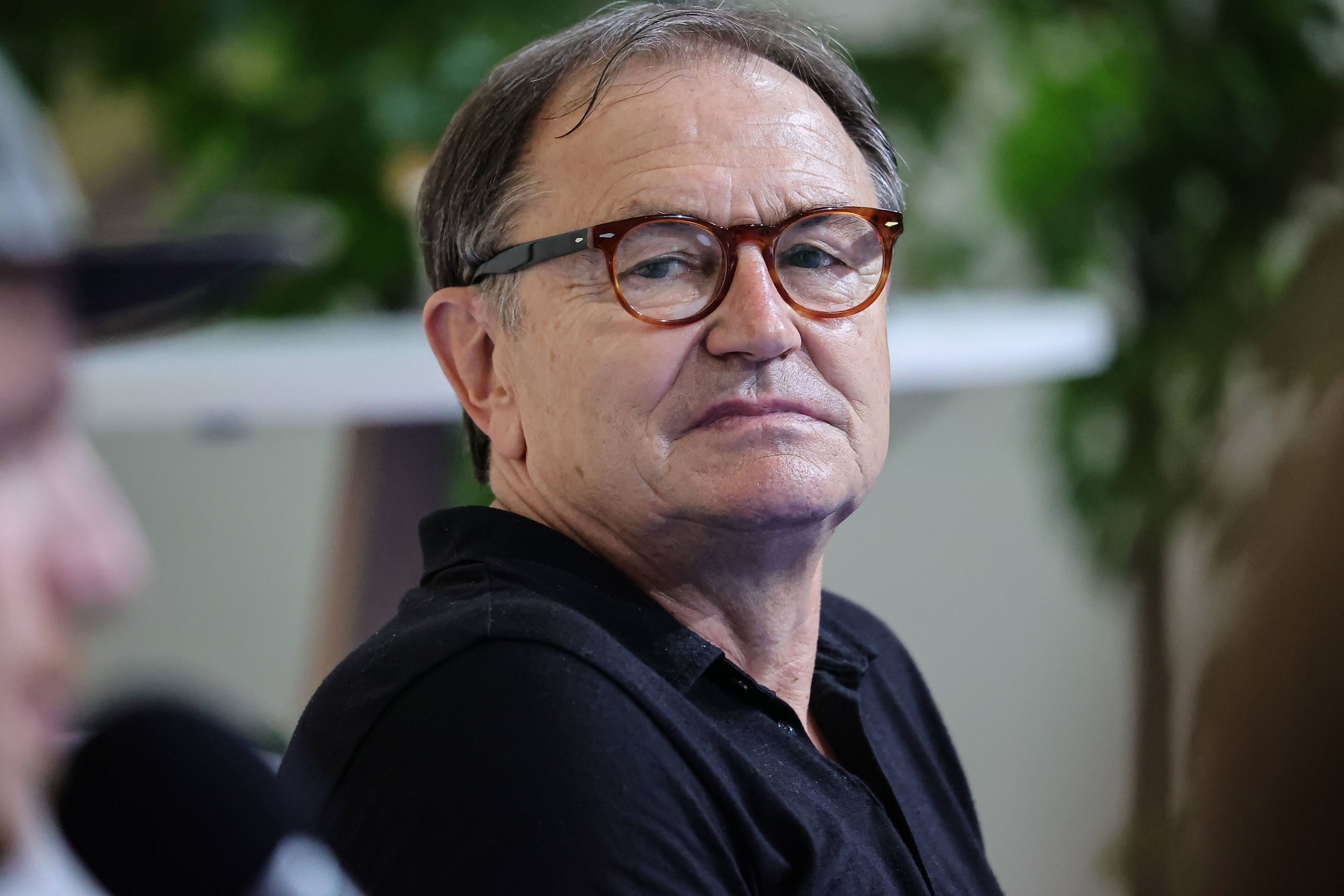Ewald Lienen, ehemaliger Trainer von Borussia Mönchengladbach und dem FC St. Pauli, nimmt am 28. August 2021 an einer Podiumsdiskussion in Düsseldorf teil. Lienen trägt ein schwarzes Polo-Shirt.
