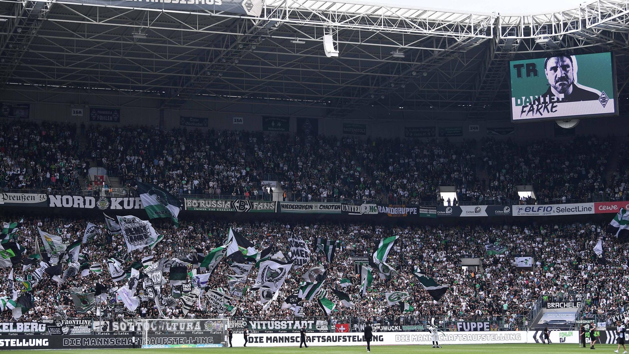 Die Fans in der Nordkurve im Borussia-Park, hier zu sehen vor dem Bundesliga-Spiel (6.Mai 2023) von Borussia Mönchengladbach gegen den VfL Bochum. Die Anhänger singen und schwenken ihre Fahnen.