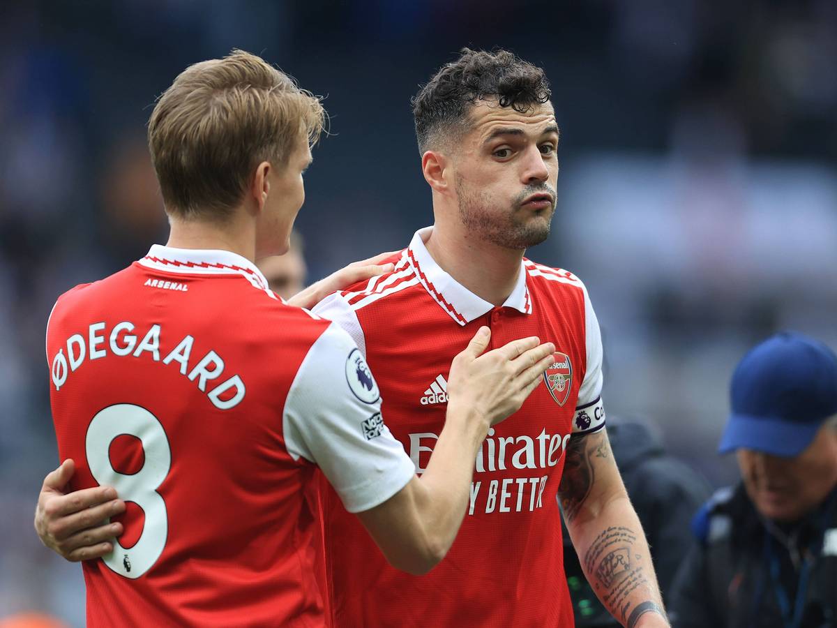 Ex-Gladbach-Kapitän und Arsenal-London-Star Granit Xhaka (r.) umarmt sichtlich erleichtert Team-Kollege Martin Odegaard (l.) nach dem Sieg im Premier-League-Duell (7. Mai 2023) bei Newcastle United. Xhaka pustet durch.