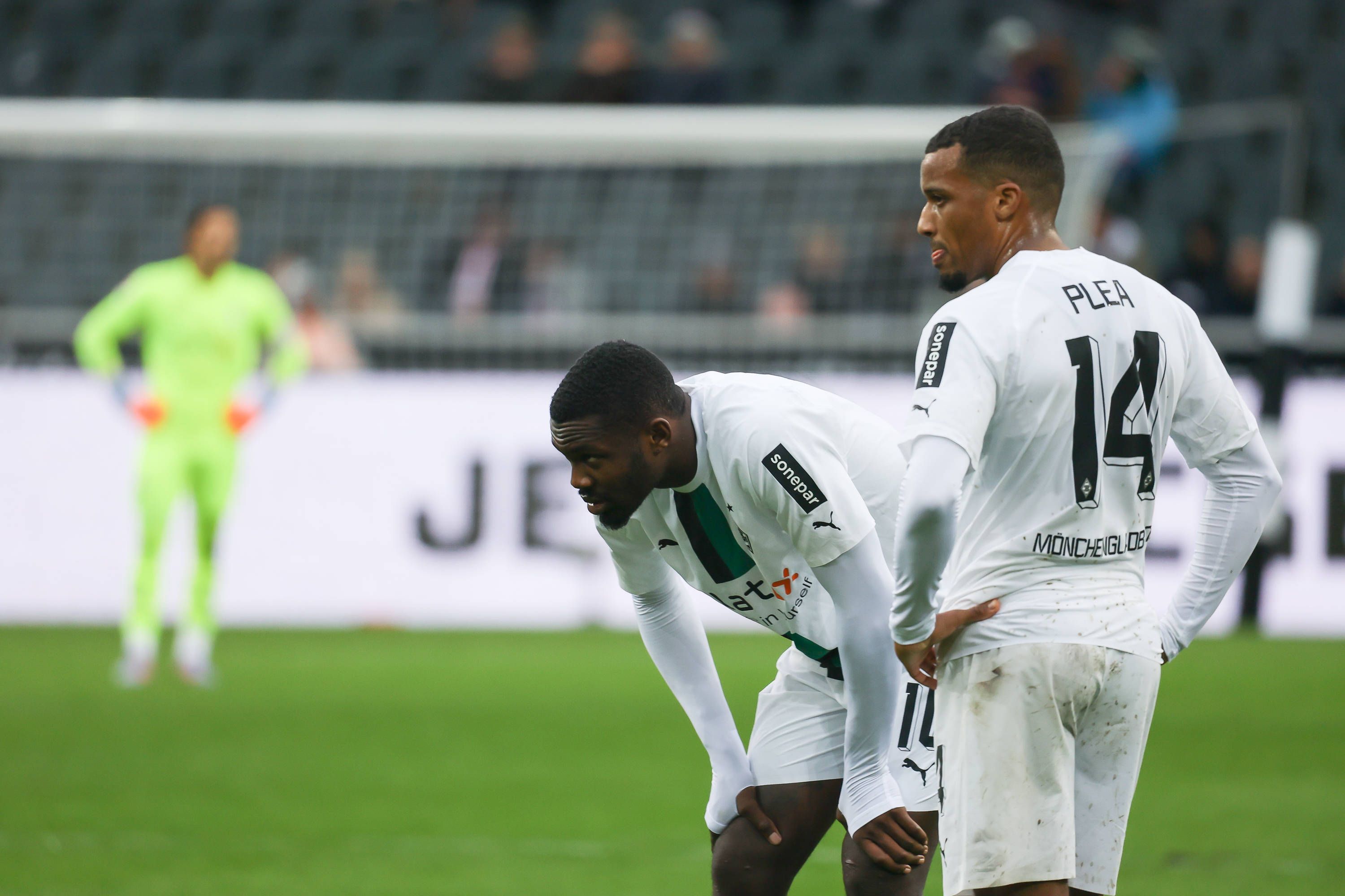 Die Gladbach-Stürmer Alassane Plea (r.) und Marcus Thuram, hier zu sehen am 14. Januar 2023 im Borussia-Park. Beide schauen unzufrieden zur Seite.