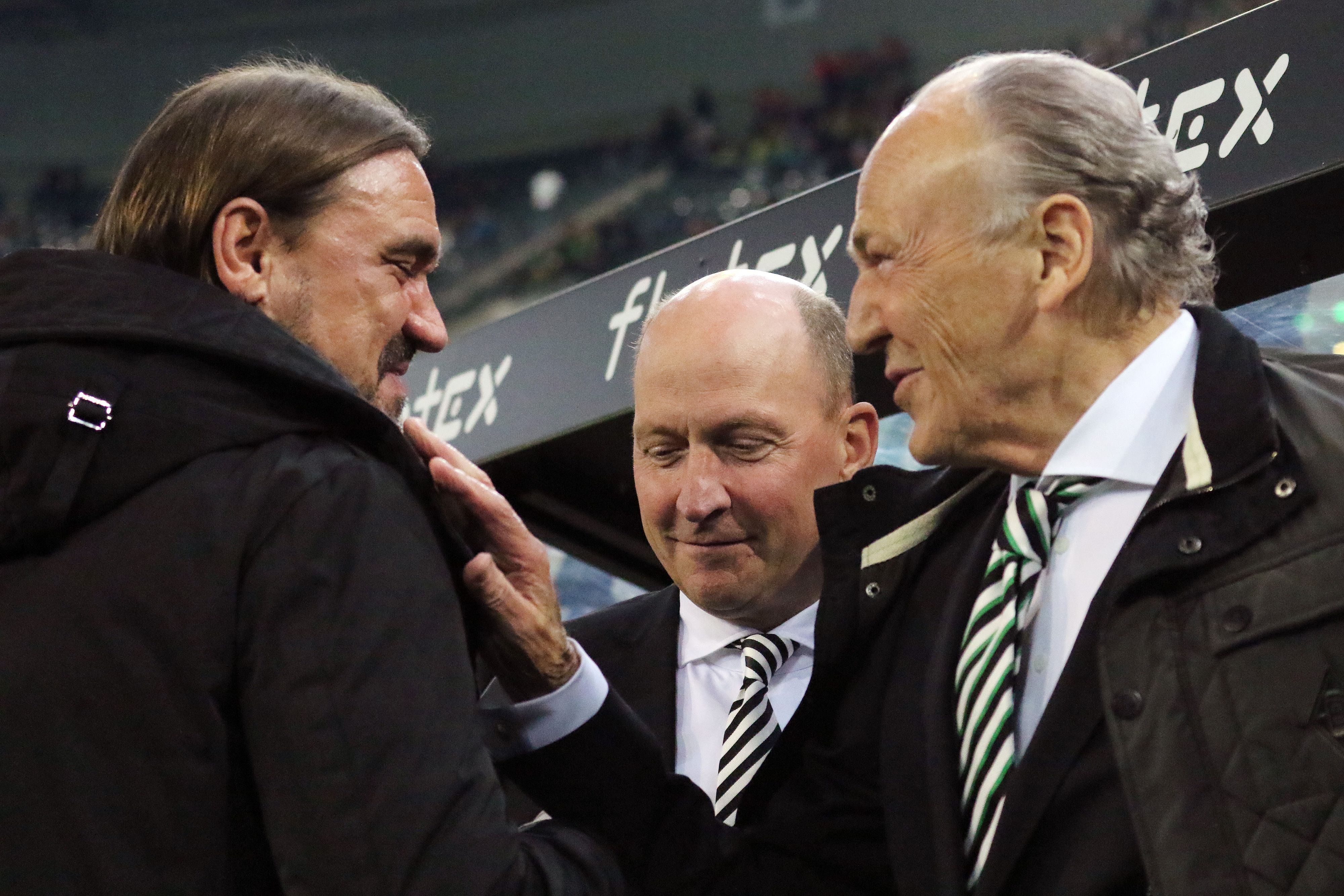 Gladbach-Präsident Rolf Königs (r.) im Gespräch mit Borussia-Trainer Daniel Farke (l.), zu sehen ist auch Finanzchef Stephan Schippers (M). Das Foto ist am 11. November 2022 im Borussia-Park entstanden. Königs lächelt und greift Farke an die Schulter.