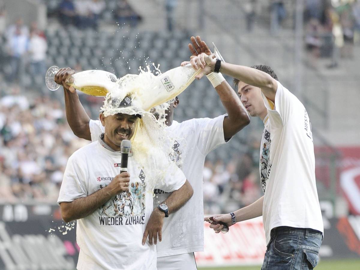 Borussia Mönchengladbach jubelt am 7. Mai 2008 über die Rückkehr in die Fußball-Bundesliga - und Aufstiegstrainer Jos Luhukay (l.) bekommt von seinen Spielern eine Bierdusche verpasst. Sebastian Schachten (r.) schüttet Luhukay Bier über den Kopf.