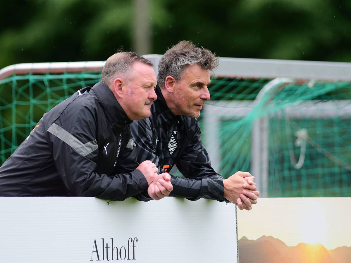 Roland Virkus (l.) und Steffen Korell stehen im Trainingslager von Borussia Mönchengladbach am 4. Juli 2022 am Spielfeldrand.