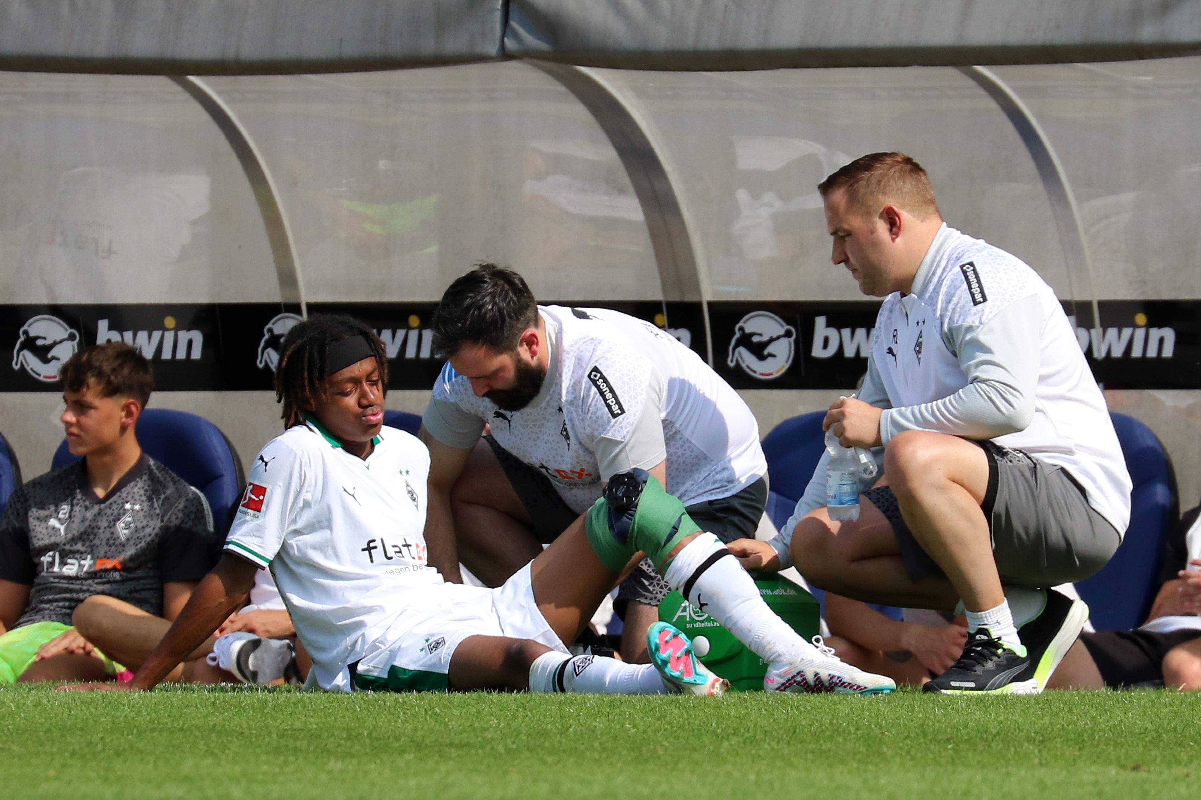 Yvandro Borges Sanches wird während des Testspiels von Borussia Mönchengladbach beim 1. FC Saarbrücken am 22. Juli 2023 am Spielfeldrand behandelt. Sein linkes Knie ist bandagiert.