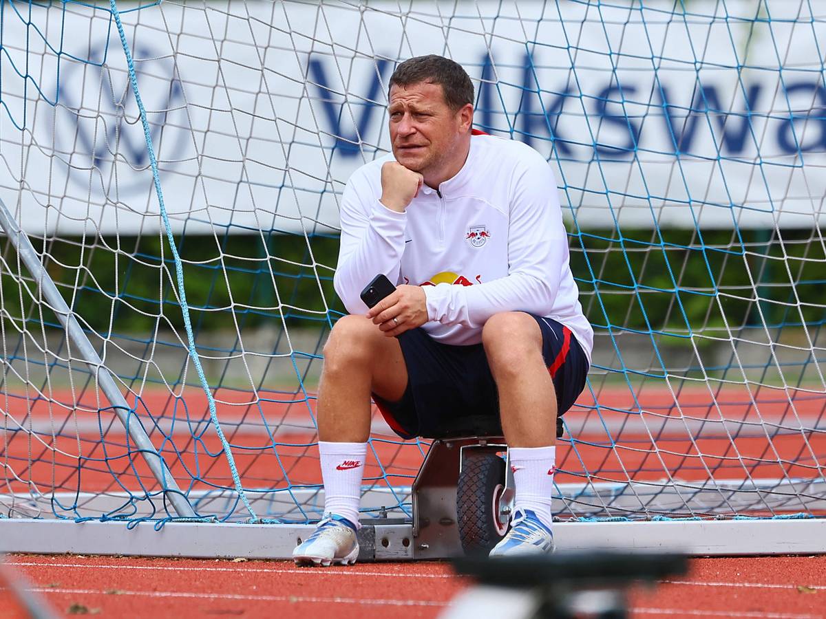 Max Eberl sitzt am Rande des Trainingsplatzes von RB Leipzig.