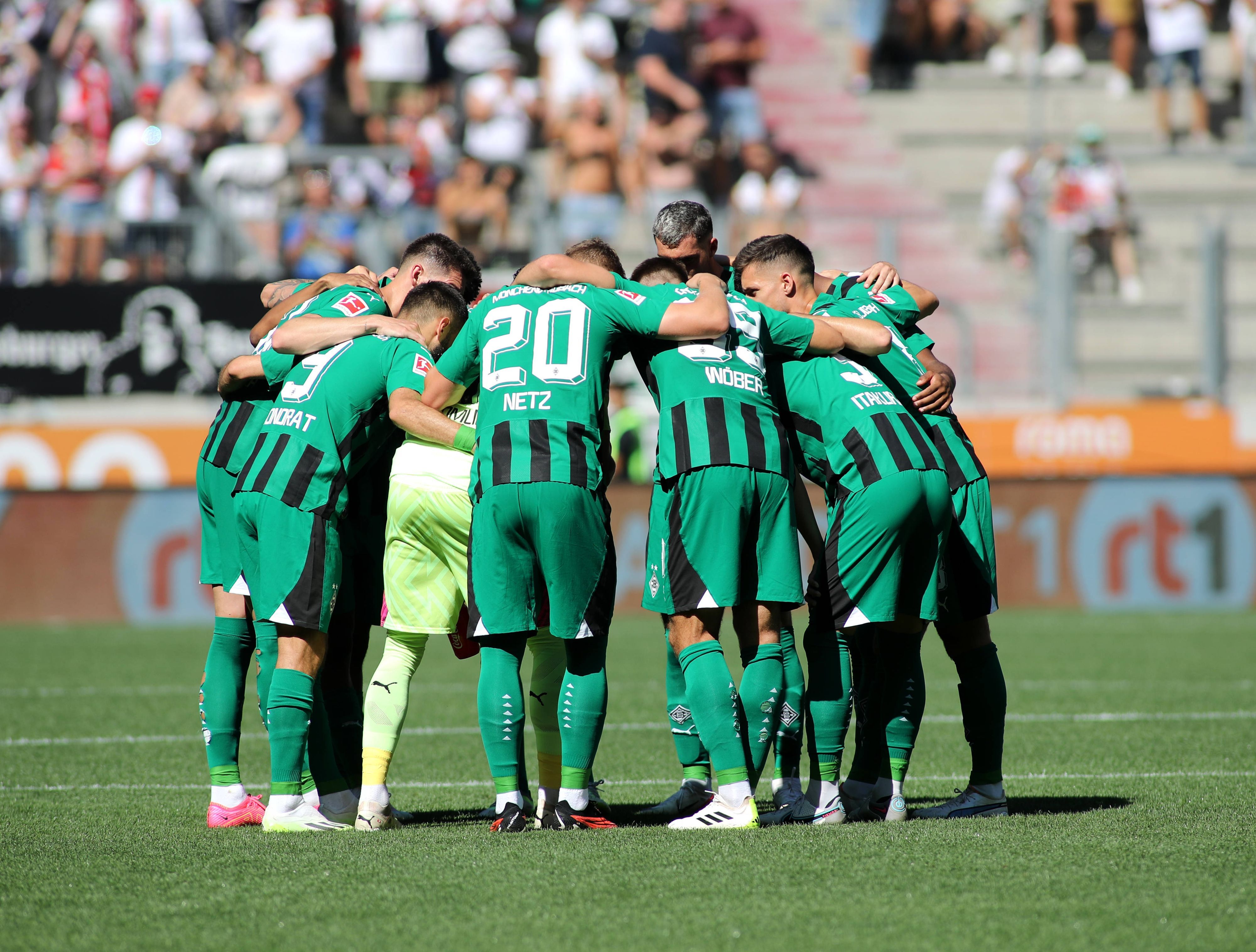 Die Spieler von Borussia Mönchengladbach bilden einen Kreis vor dem Spiel.