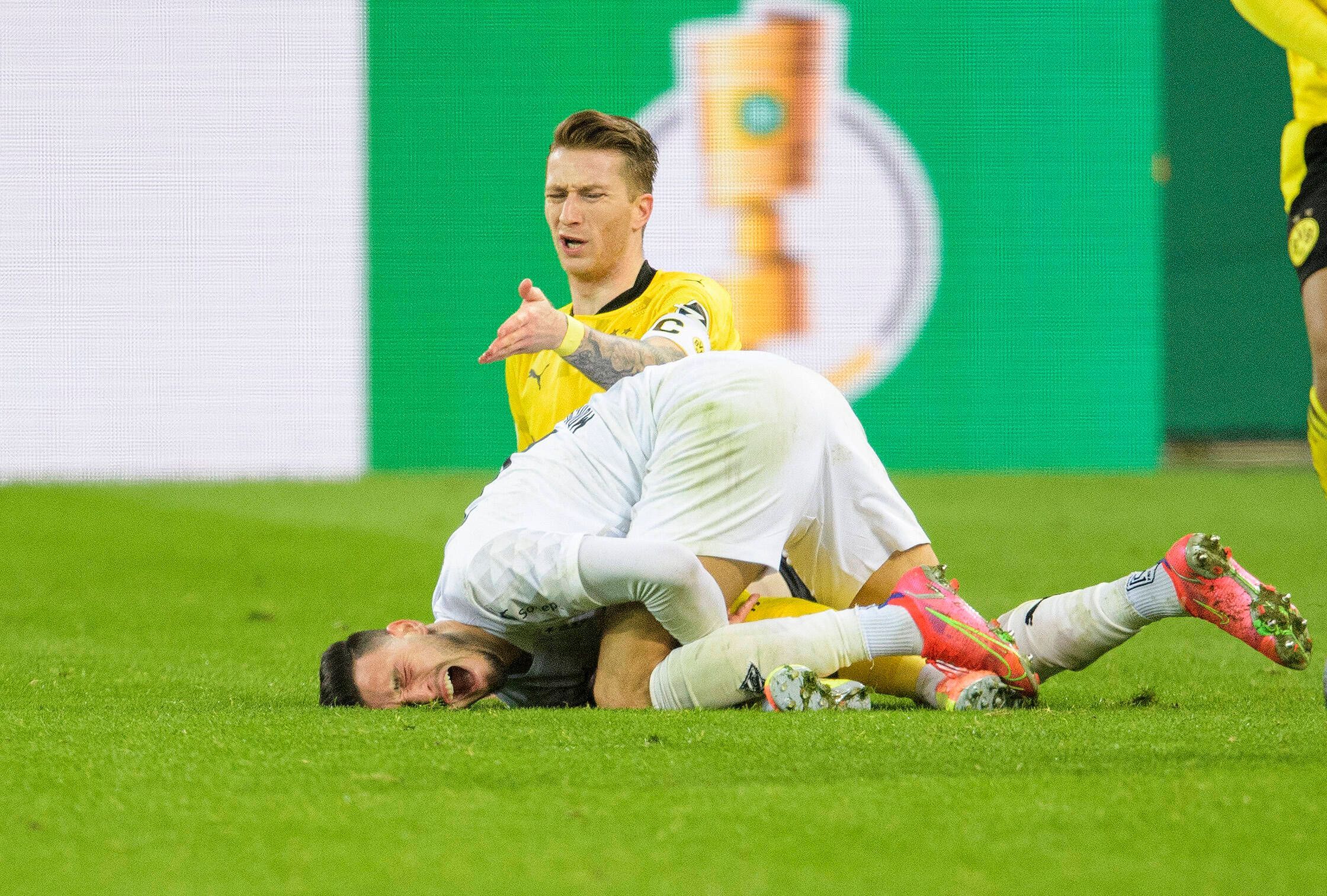 Ramy Bensebaini und Marco Reus nach einem Zweikampf.