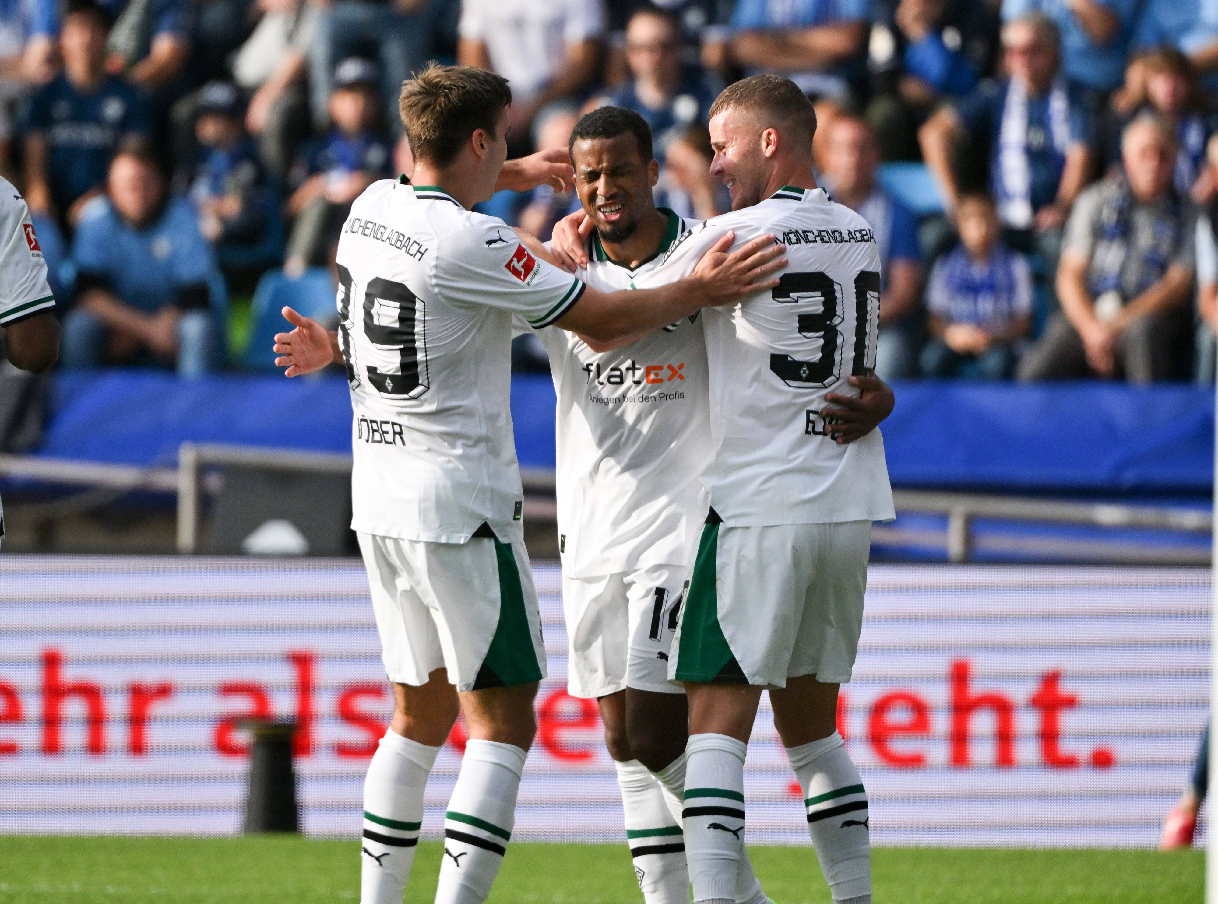 Maximilian Wöber und Nico Elvedi von Borussia Mönchengladbach gratulieren dem Torschützen Alassane Plea beim Spiel gegen den VfL Bochum.