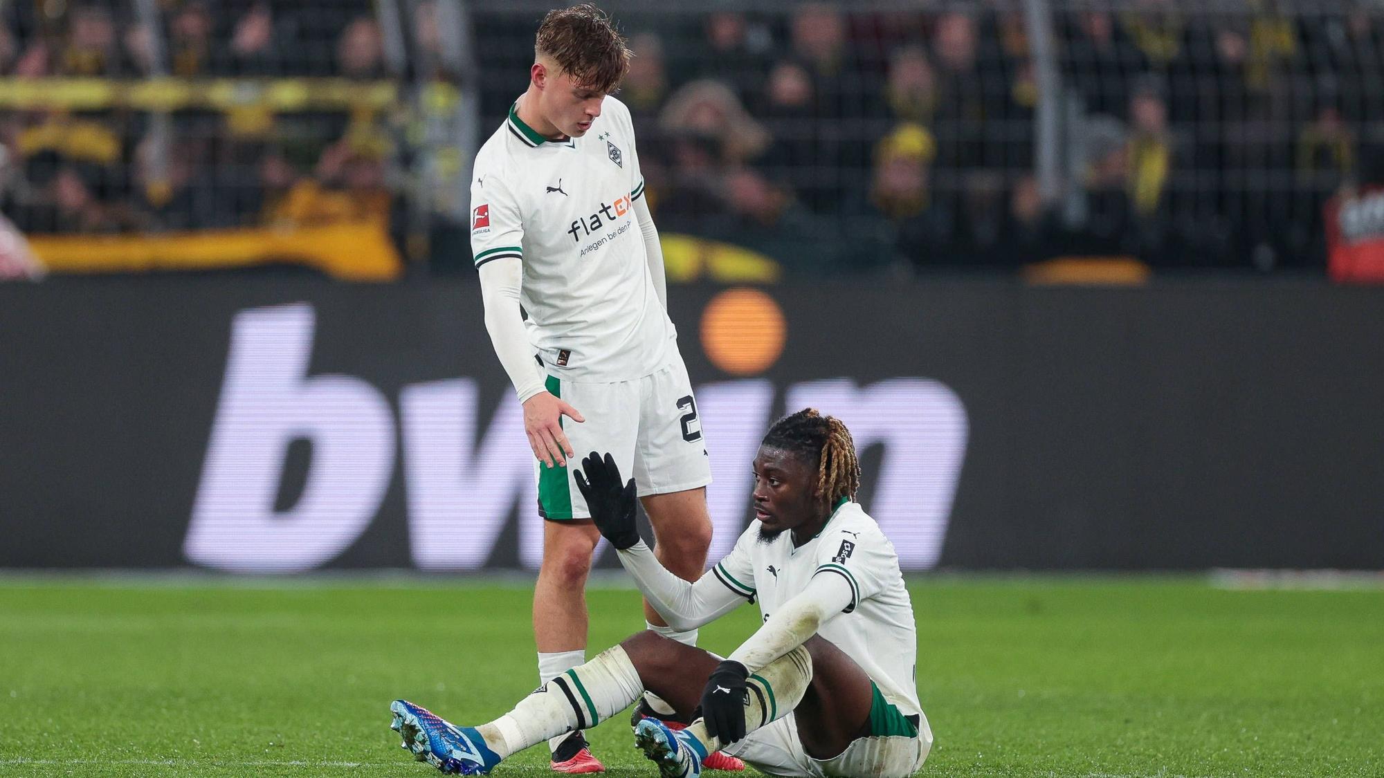 Luca Netz hilft Manu Kone vom Boden auf.