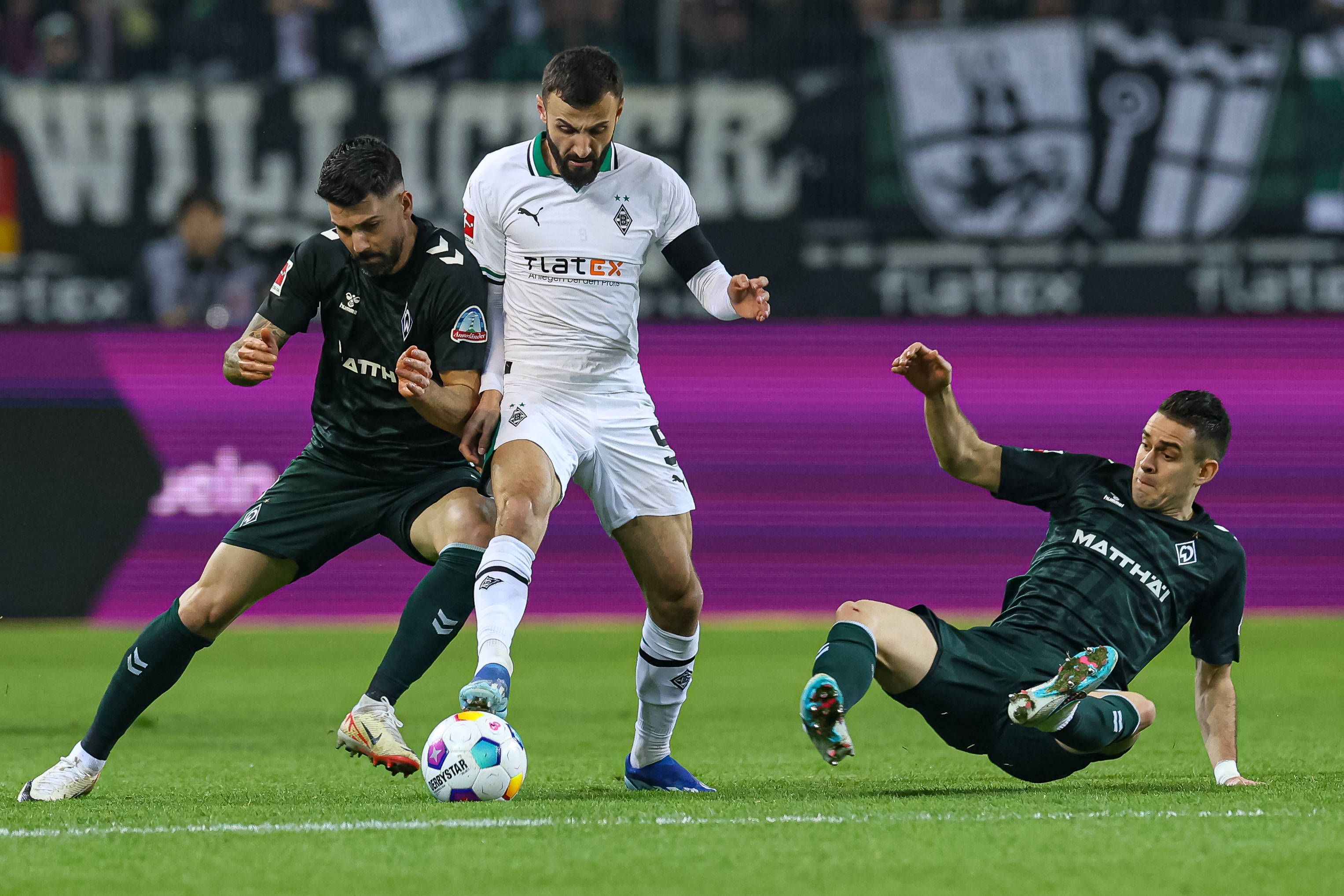 Franck Honorat versucht, den Ball gegen zwei Spieler von Werder Bremen zu behaupten.