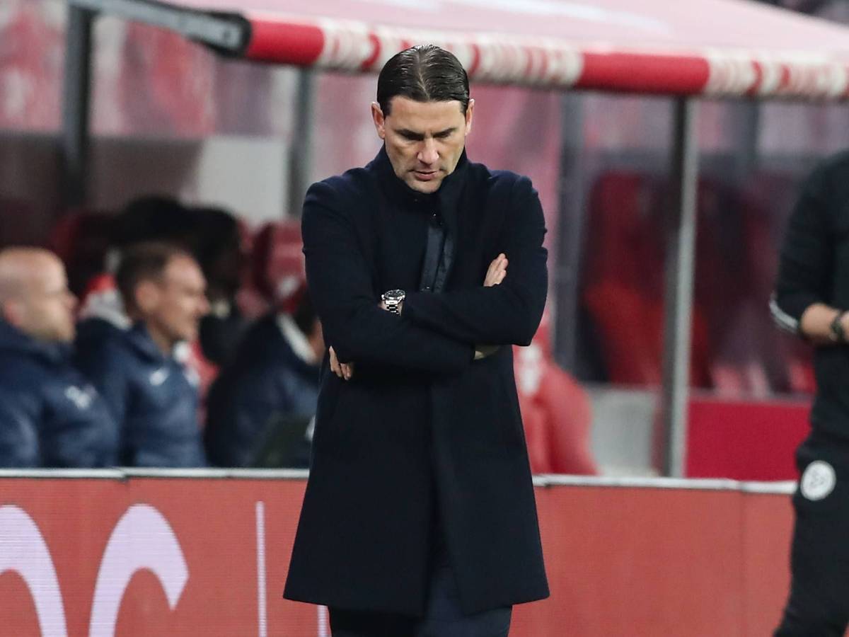 Trainer von Borussia Mönchengladbach verschränkt die Arme und schaut auf den Boden.