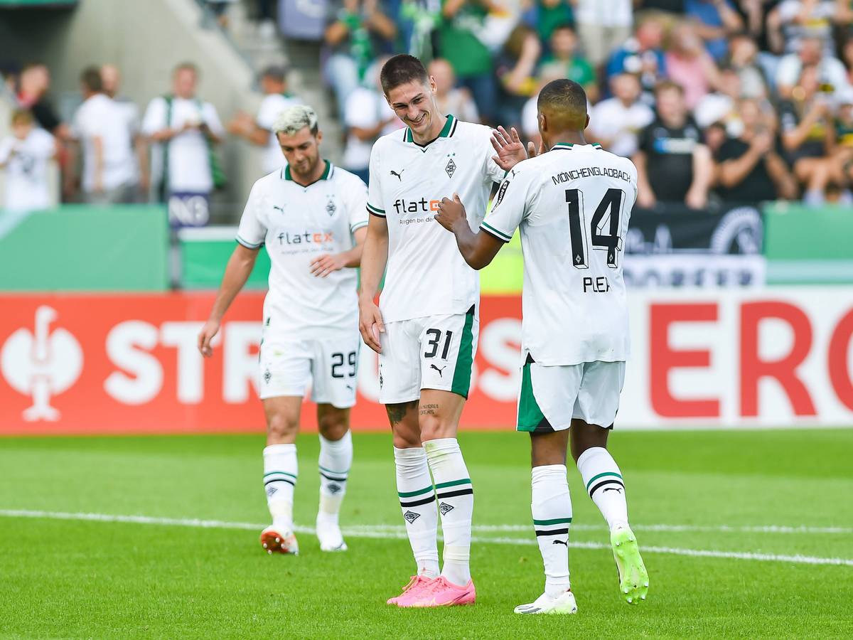 Zwei Spieler von Borussia Mönchengladbach klatschen sich gegenseitig ab.