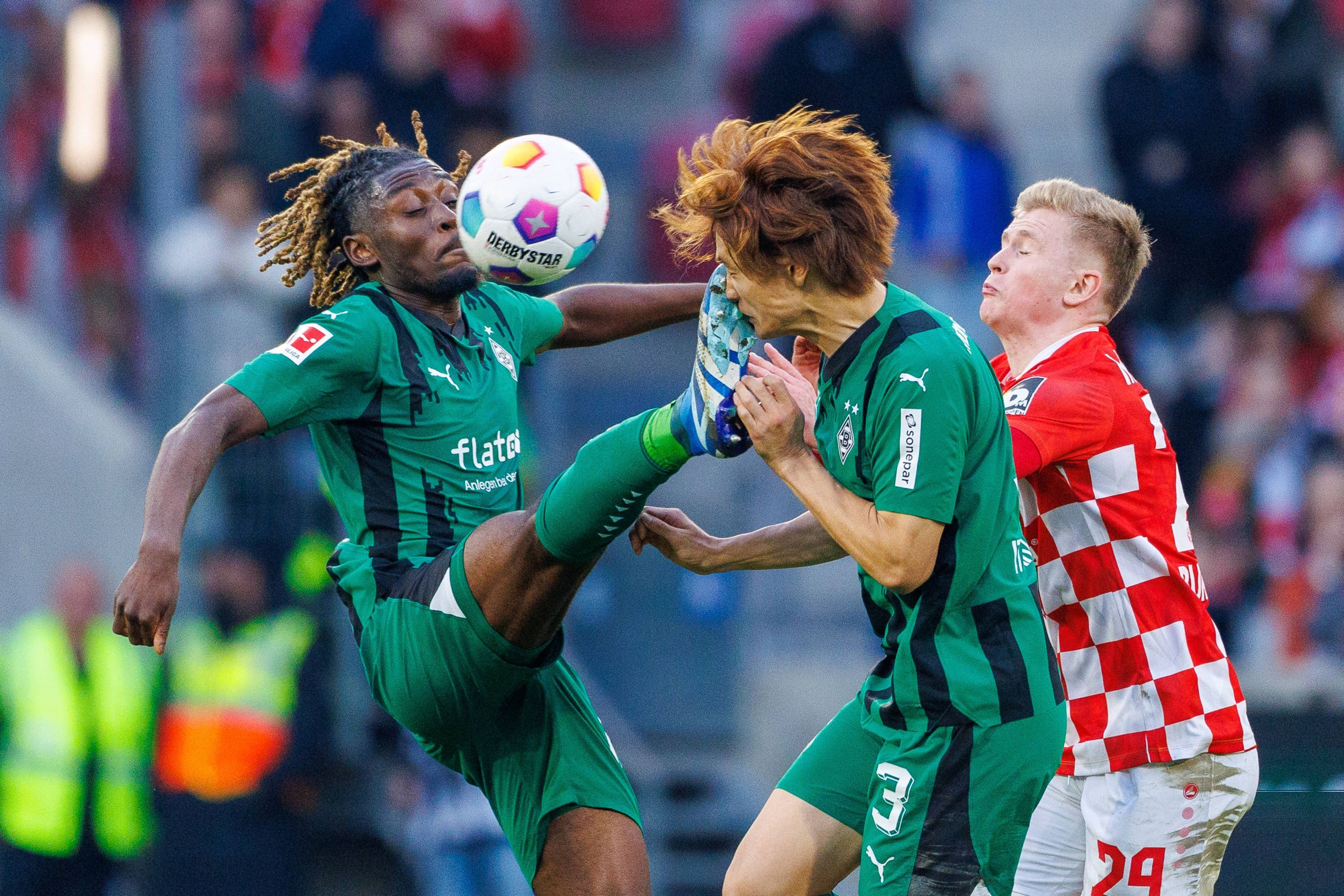 Borussia Mönchengladbachs Manu Koné tritt seinem Team-Kollegen Ko Itakura ins Gesicht.