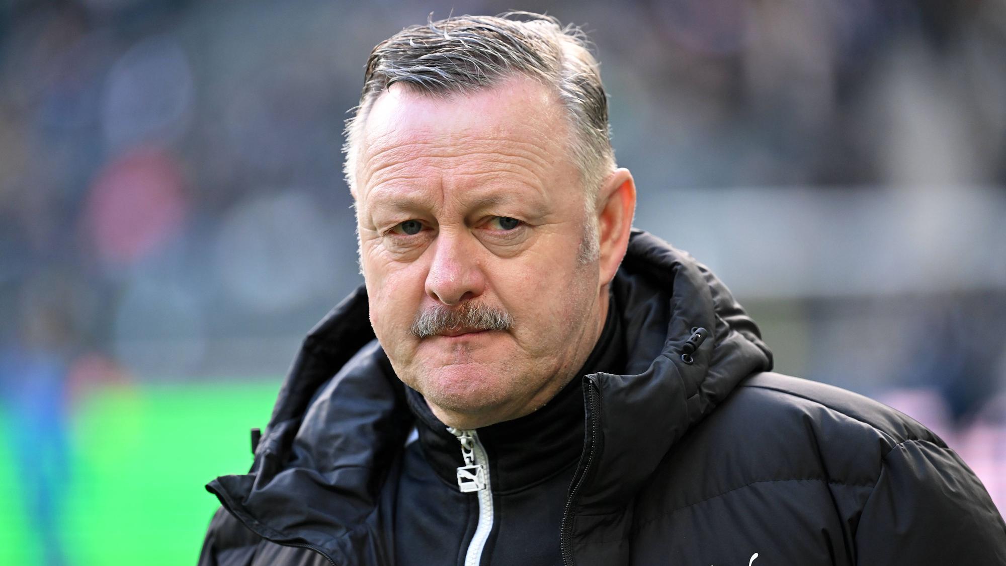 Roland Virkus in schwarzer Jacke, mit ernstem Blick.