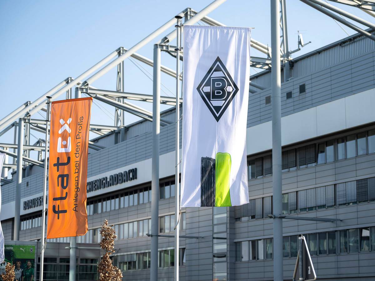Eine Borussia-Fahne und eine Sponsoren-Flagge vor dem Borussia-Park.