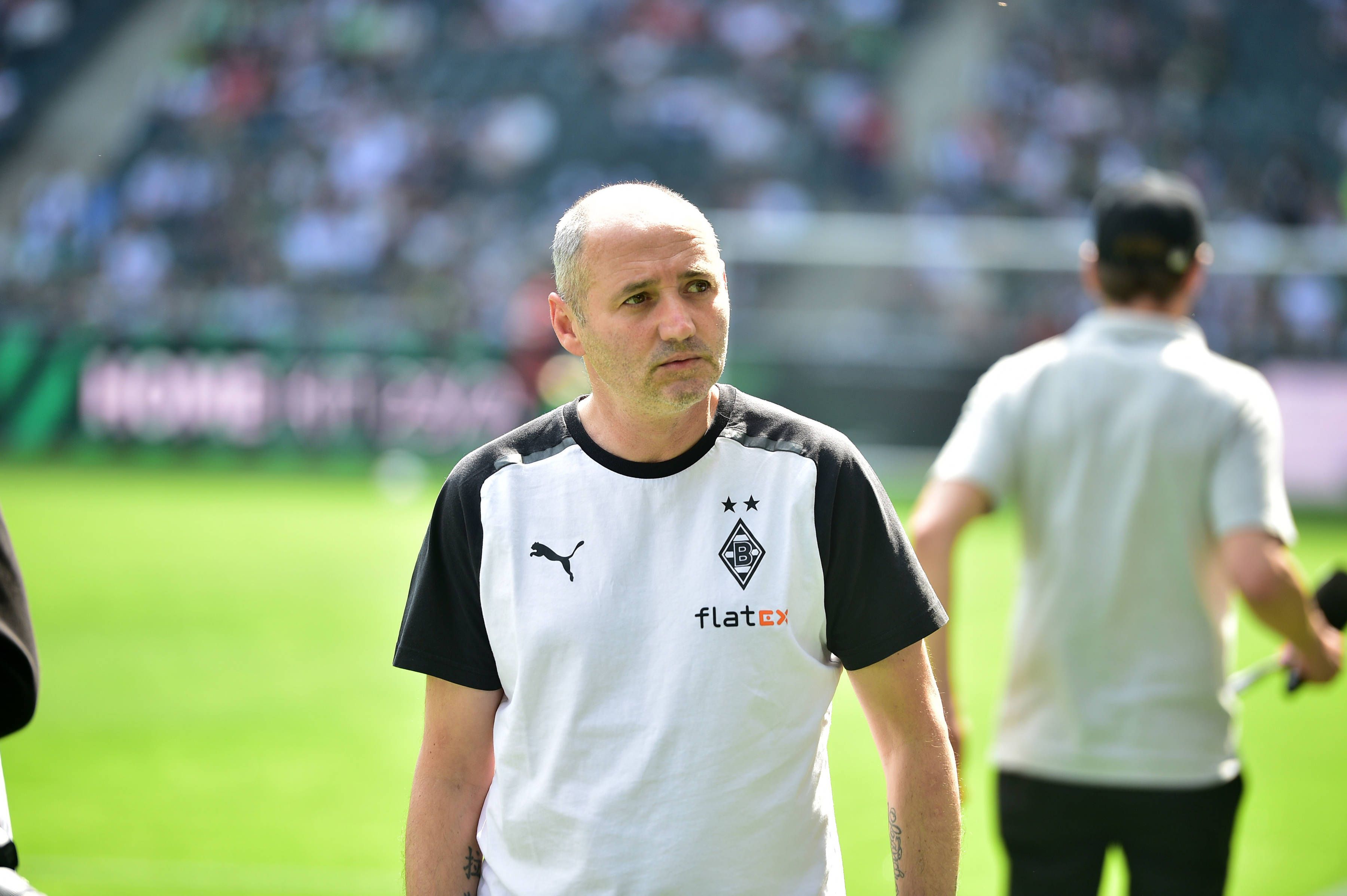 Oliver Neuville im Borussia-Shirt neben dem Platz.