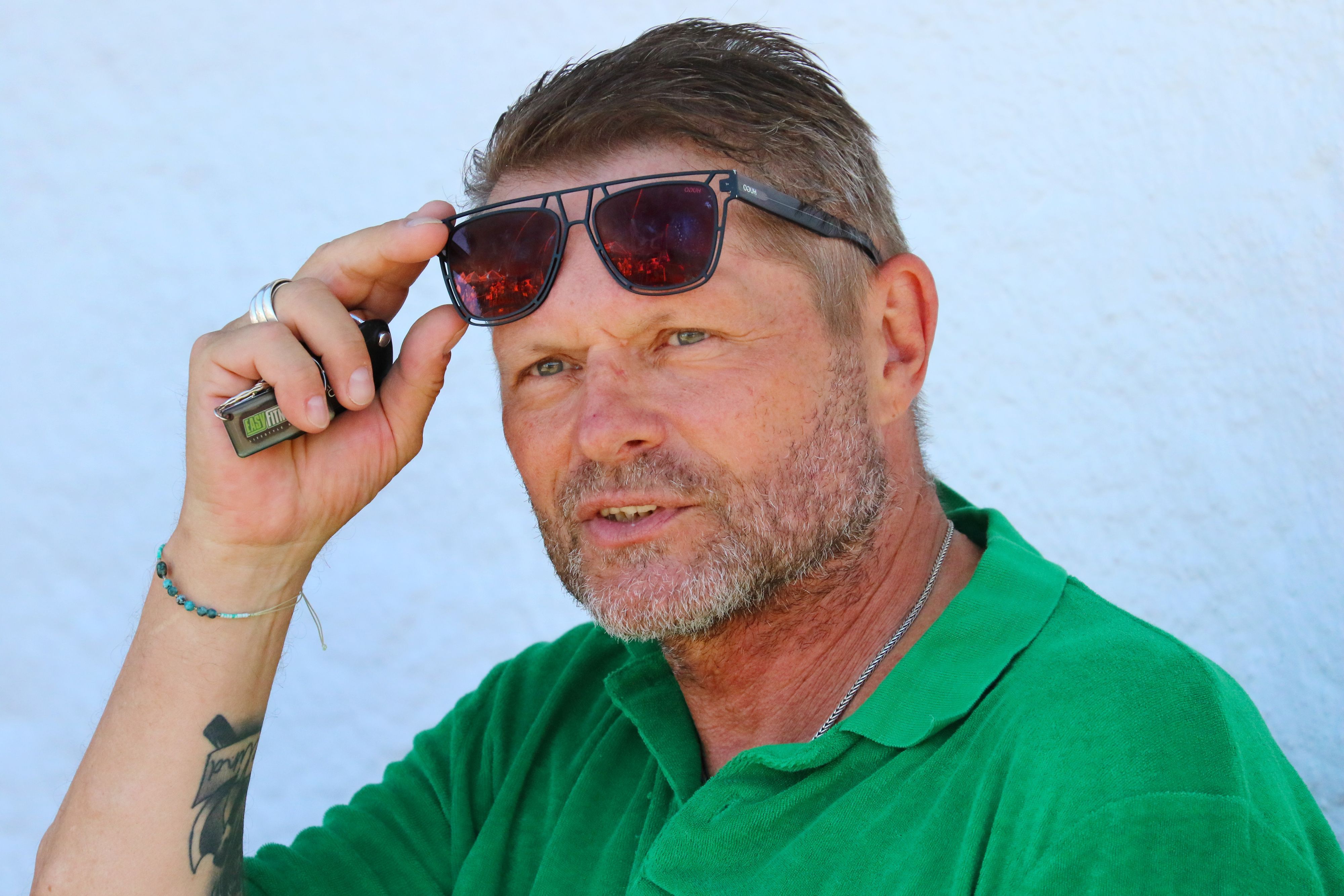 Uli Borowka schiebt sich die Sonnenbrille auf die Stirn.