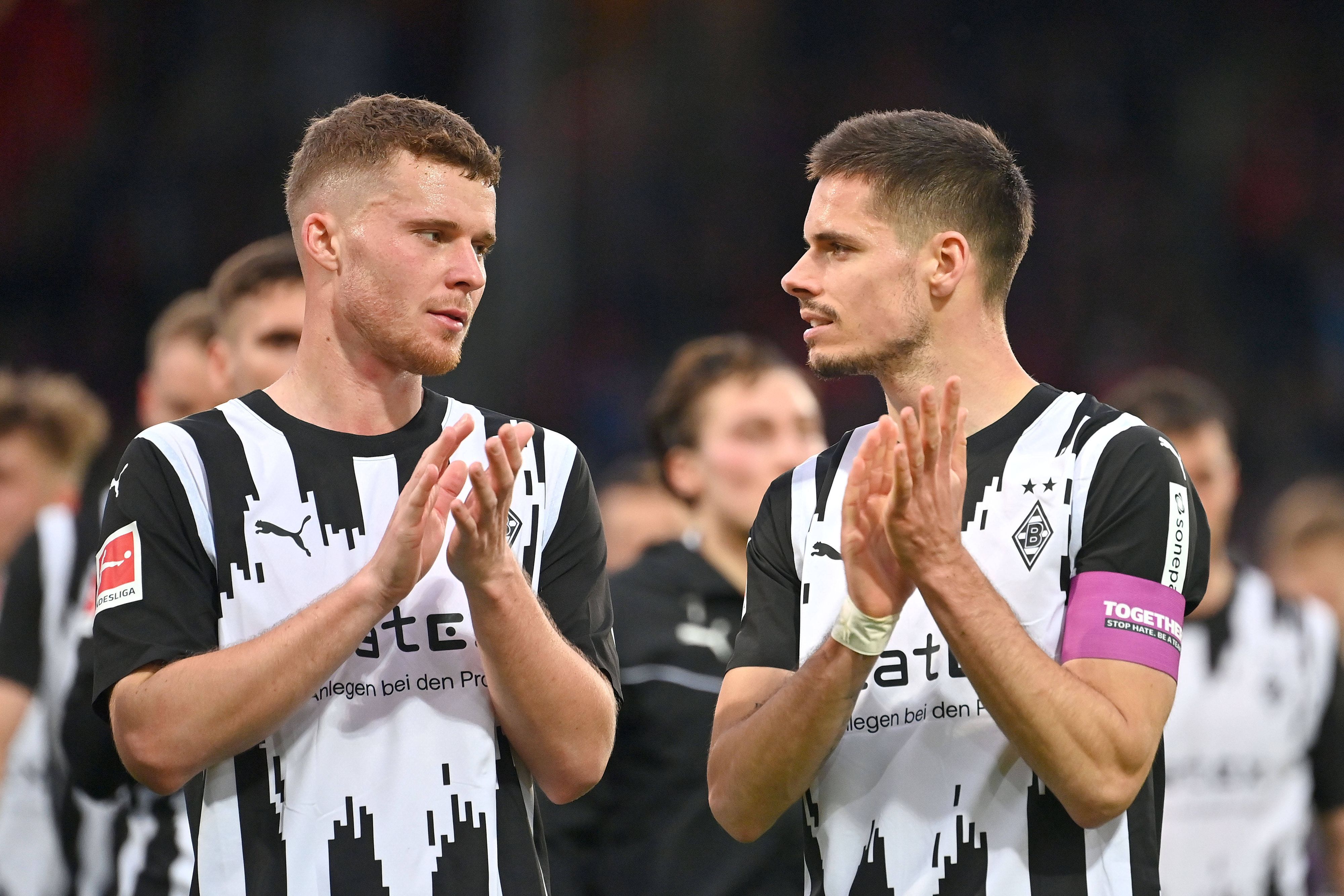 Die Mönchengladbach-Profis Nico Elvedi und Julian Weigl stehen nebeneinander auf dem Platz und applaudieren den Fans.