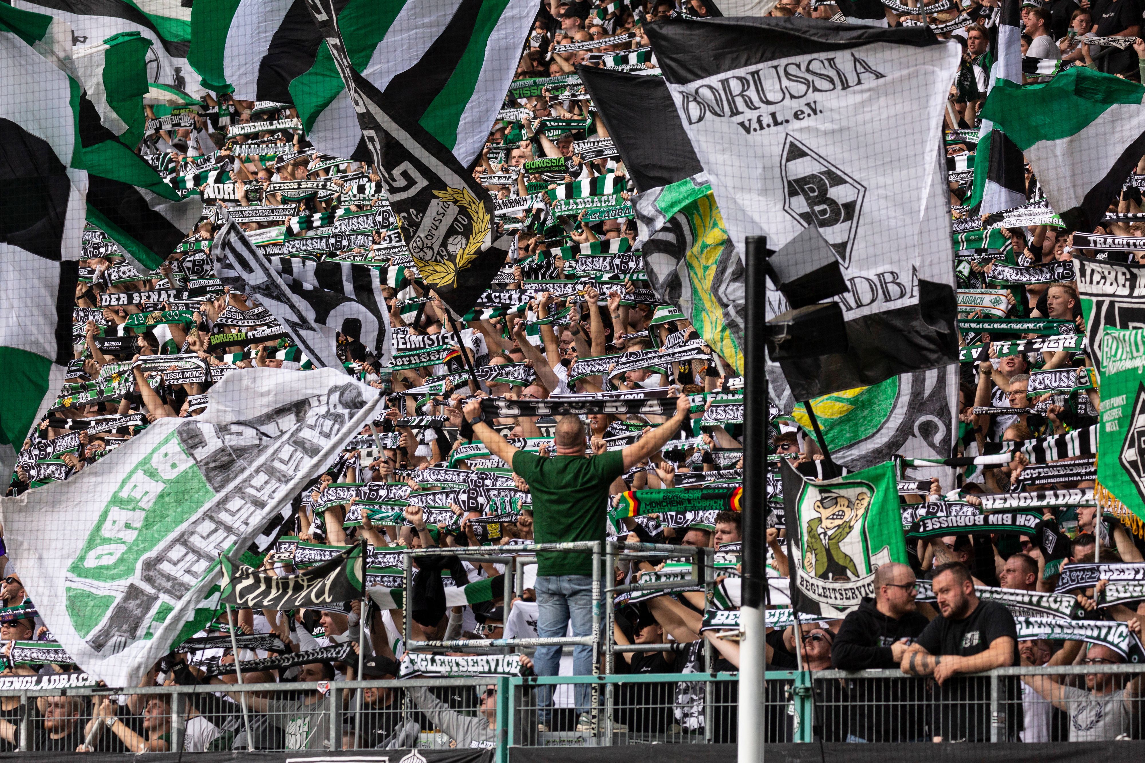 Die Fans in der Nordkurve heben den Schal in die Höhe.