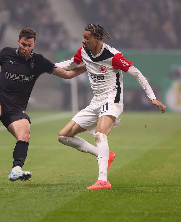 Borussia Mönchengladbachs Joe Scally und Eintracht Frankfurts Hugo Ekitiké kämpfen um den Ball.